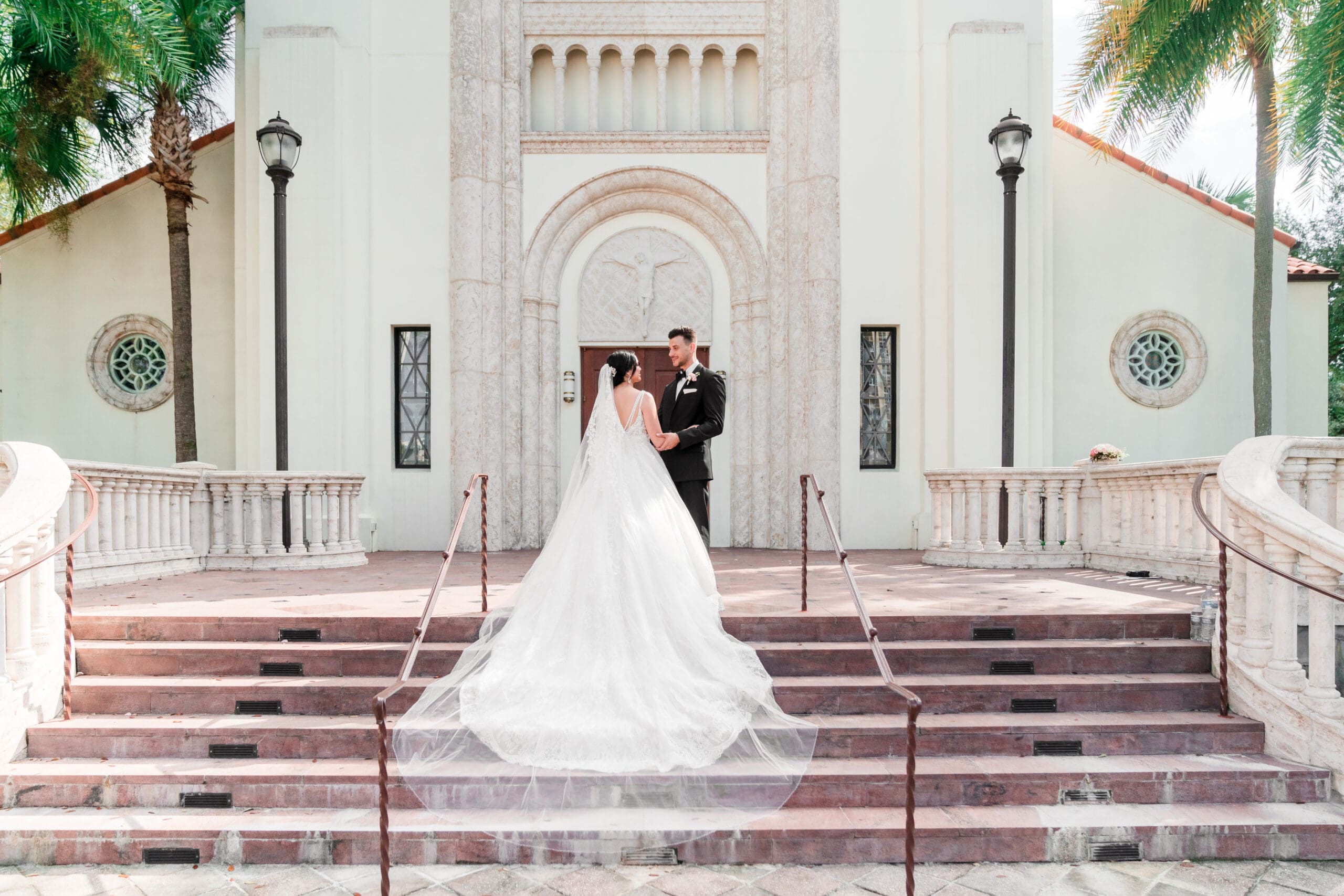Jessica and Javier embracing arm in arm, gazing into each other's eyes in front of St. James Cathedral.
