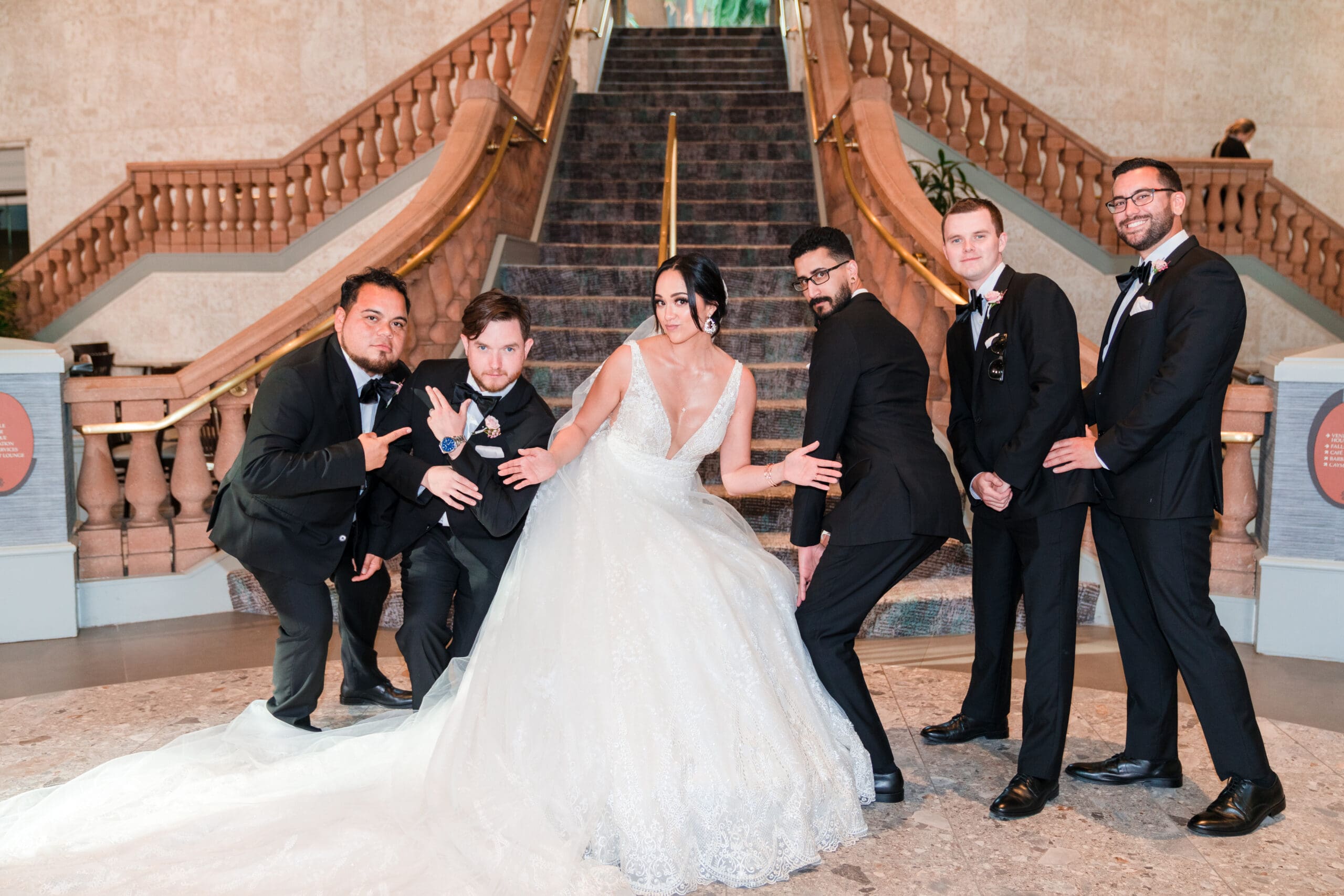 Wide shot capturing the bride with groomsmen at Royale Caribe Orlando, brimming with fun and personality.