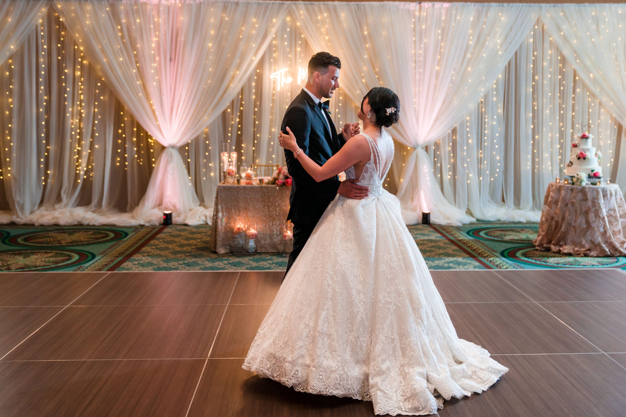 Wide shot capturing Jessica and Javier's first dance at the Orlando Royale Caribe reception center, surrounded by guests, beautifully photographed by Jerzy Nieves Photography.