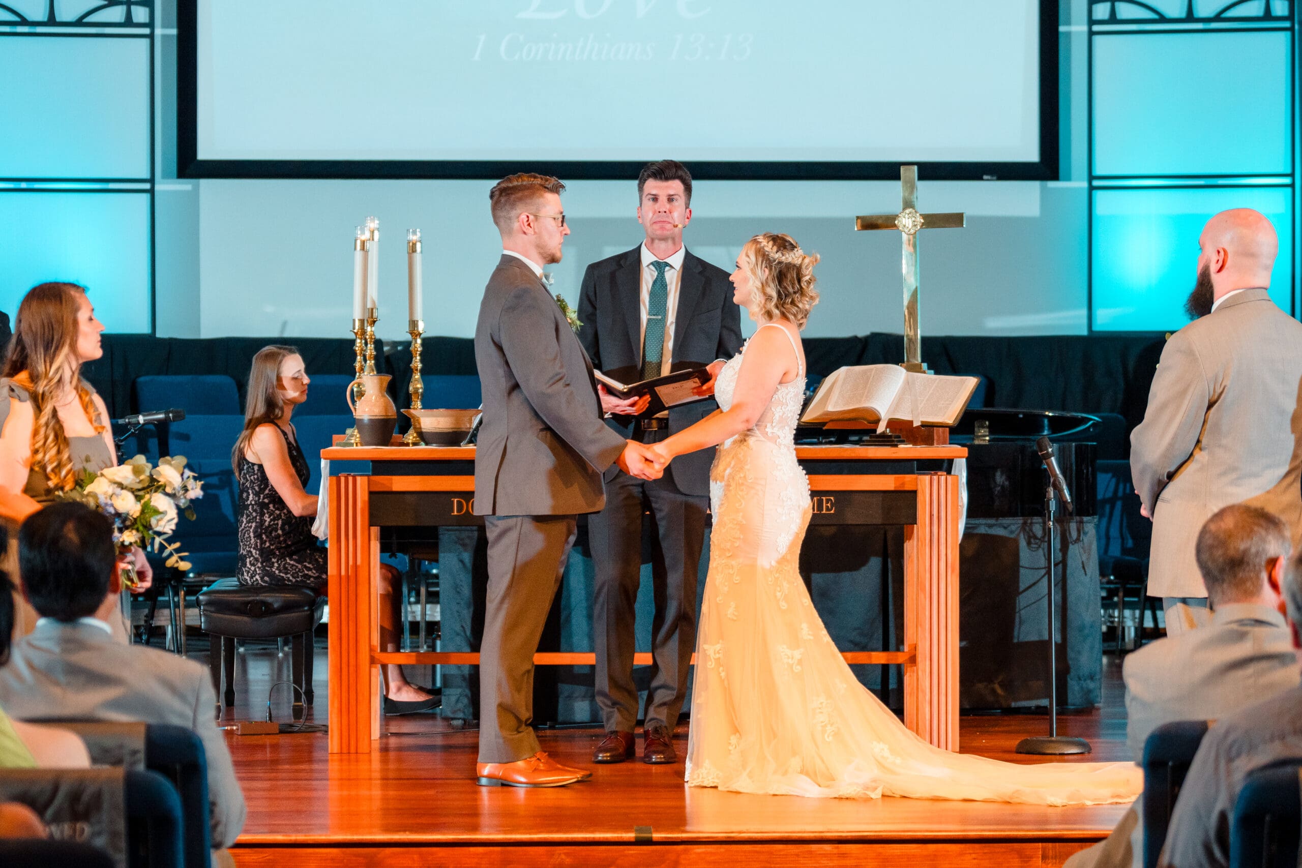 Delisa and Preston holding hands at the altar