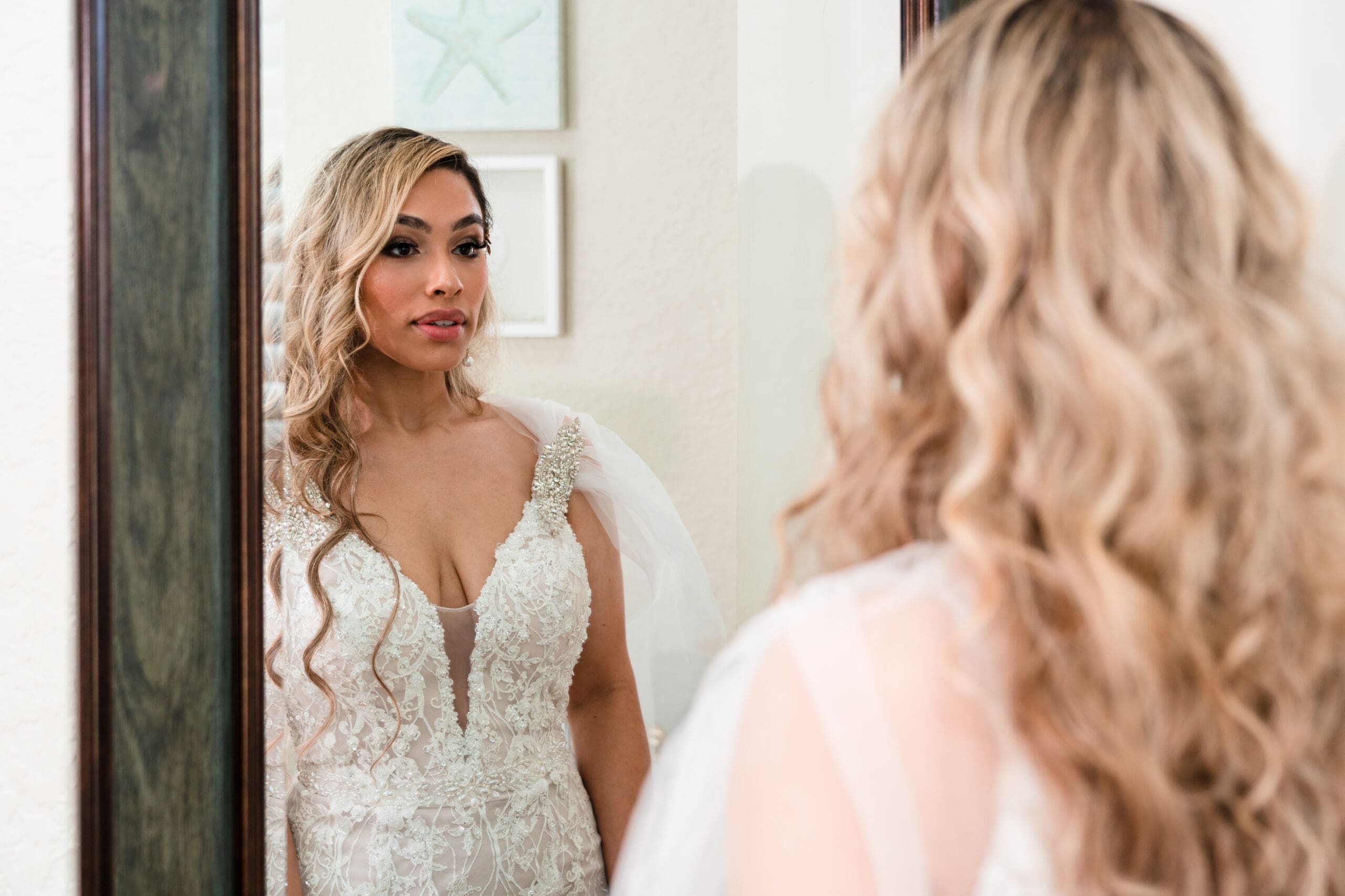 Jenn admiring her final bridal look in the mirror of the bridal suite at the Crystal Ballroom