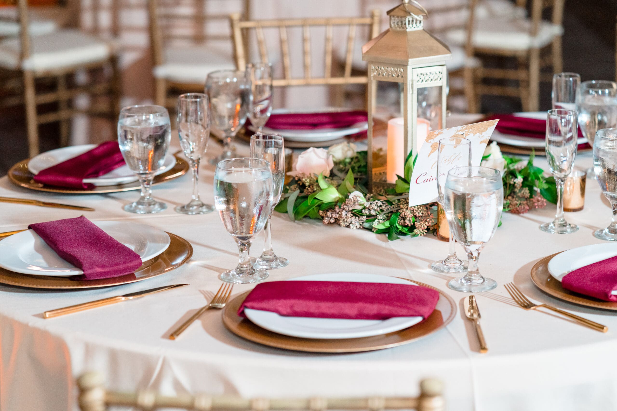 Close-up shot of elegantly adorned guest tables with gold plates and silverware at Paradise Cove.
