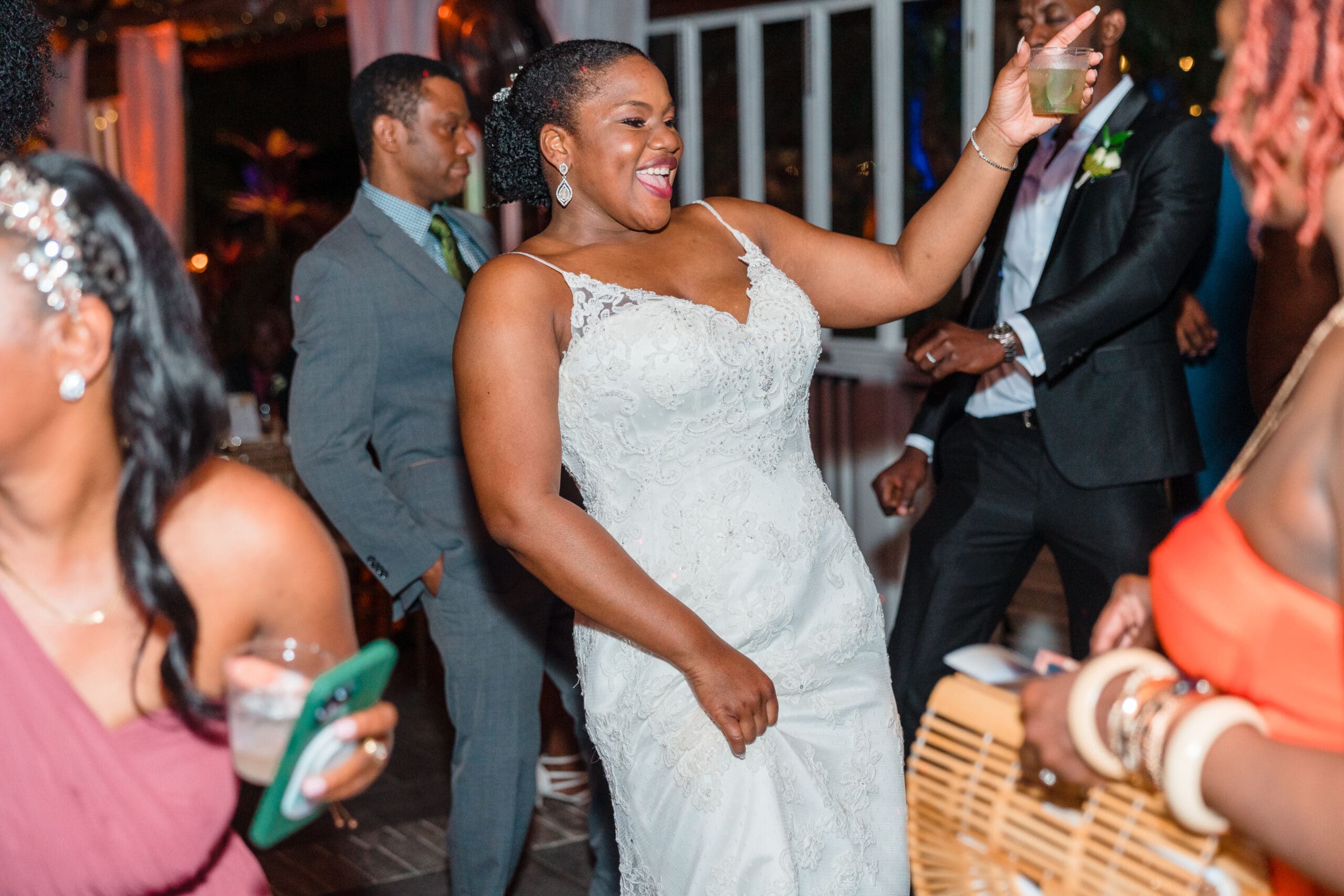 Kourtni having a blast on the dance floor with her guests, drink in hand, at Paradise Cove, captured by Jerzy Nieves Photography.