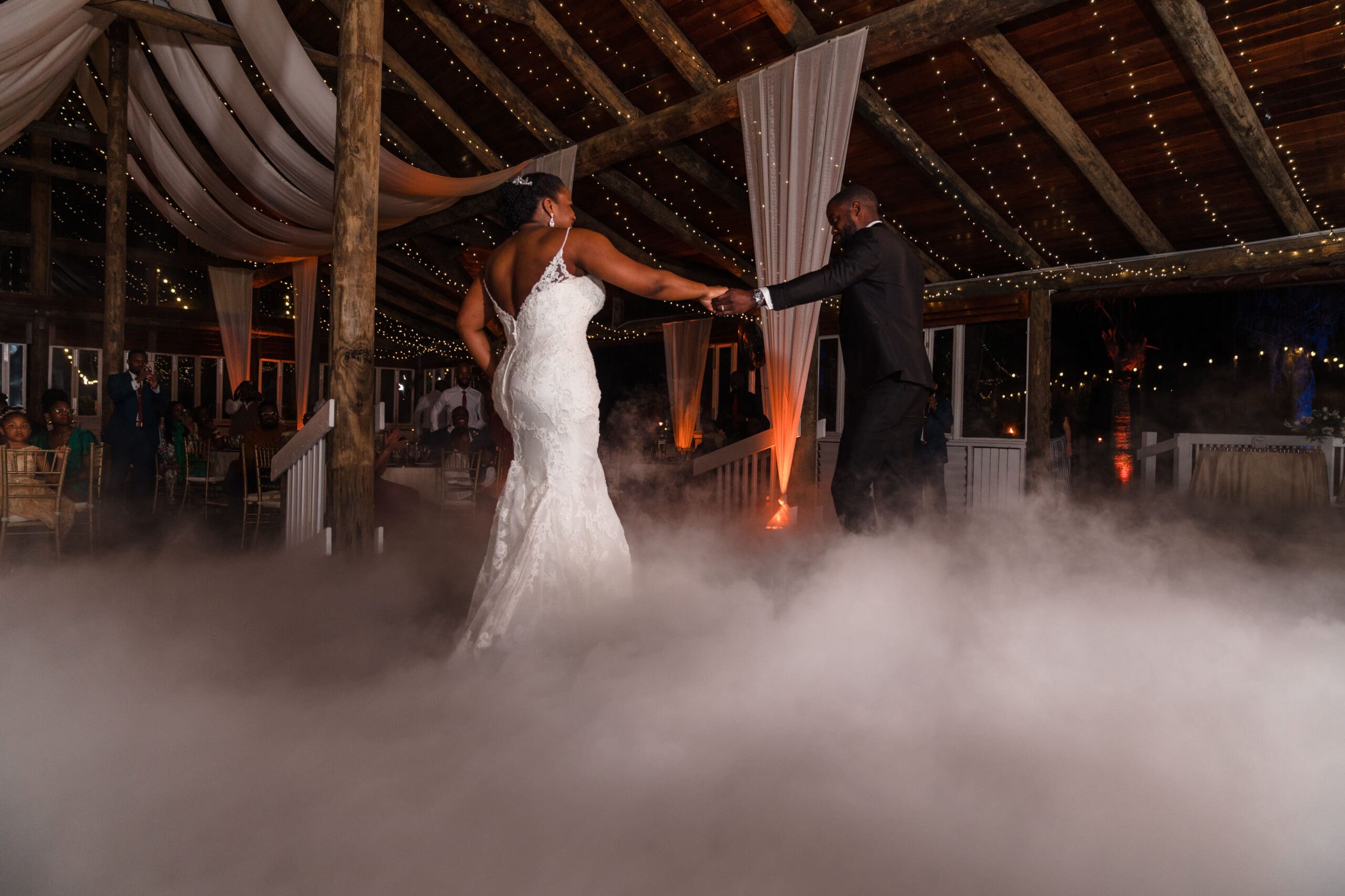 Wide shot capturing Kourtni and Jamie's dynamic dance move above the fog-filled dance floor at Paradise Cove reception.