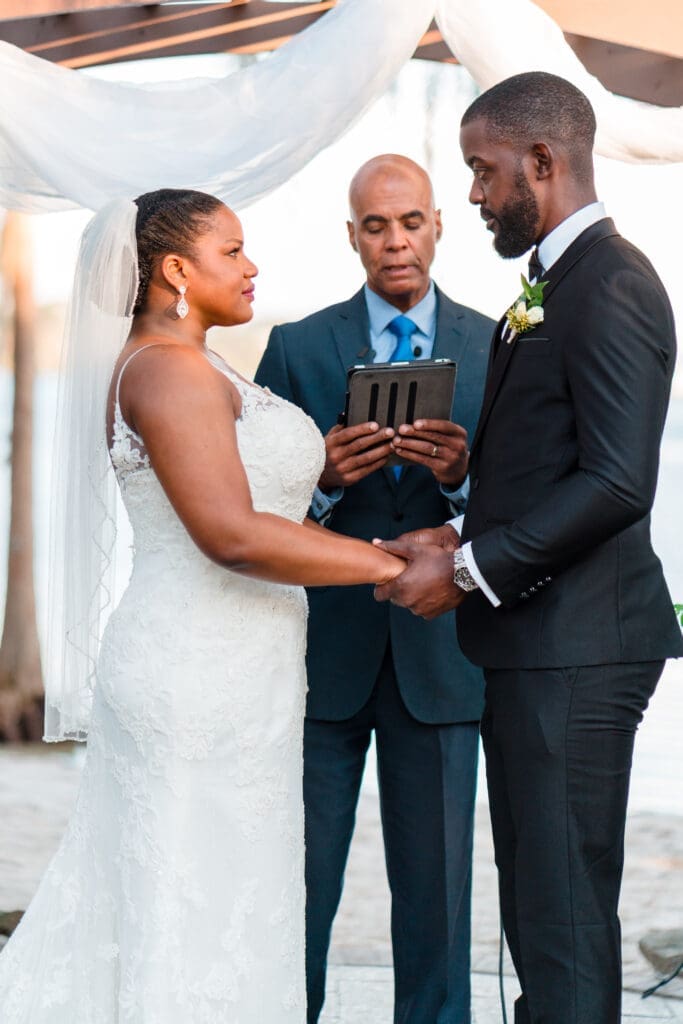 Tall shot capturing Kourtni and Jamie with the officiant at the altar during their Paradise Cove wedding ceremony.