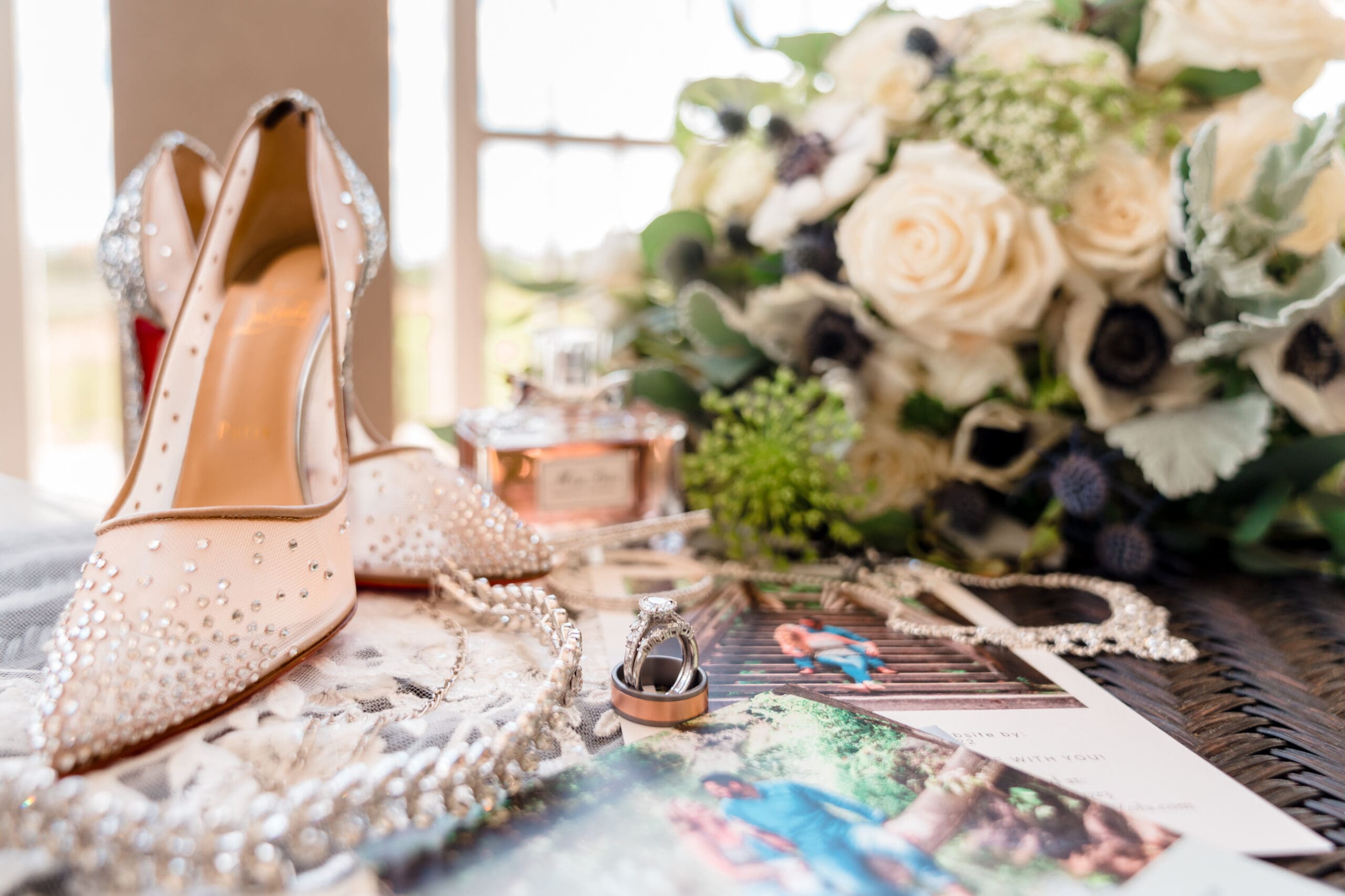 Close-up of wedding rings and bridal shoes