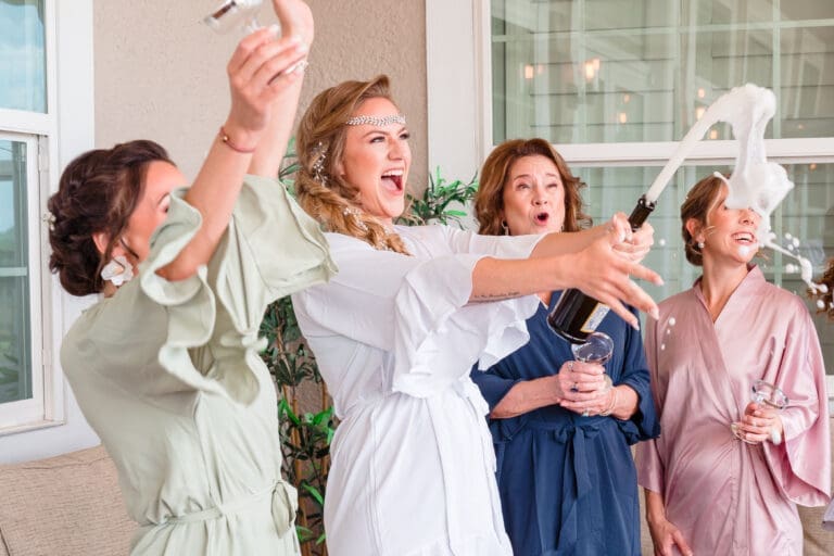 Kristen, Mom, and Bridesmaids Opening Champagne