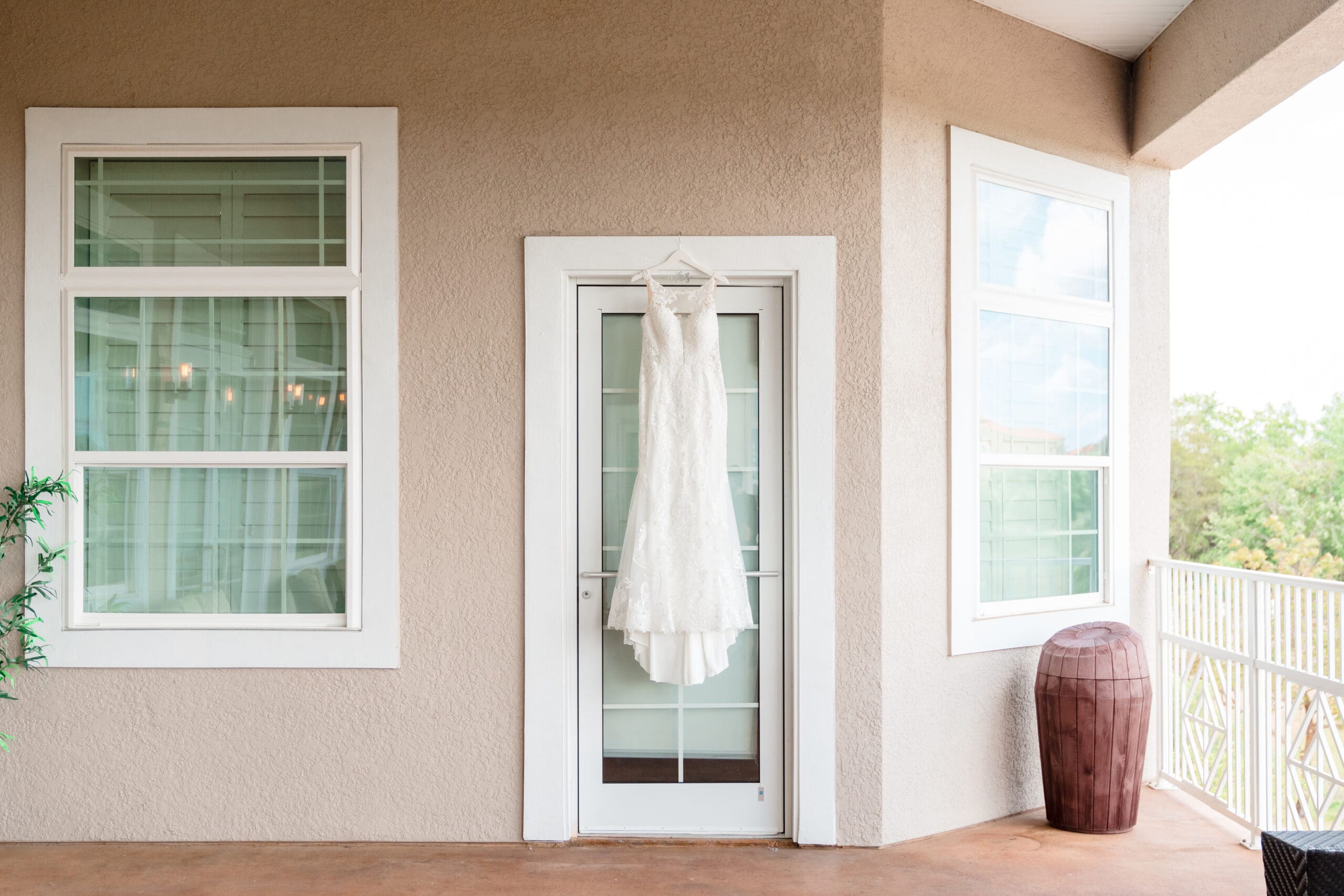 Wedding dress hanging on a rustic wooden door at Island Grove Winery Company