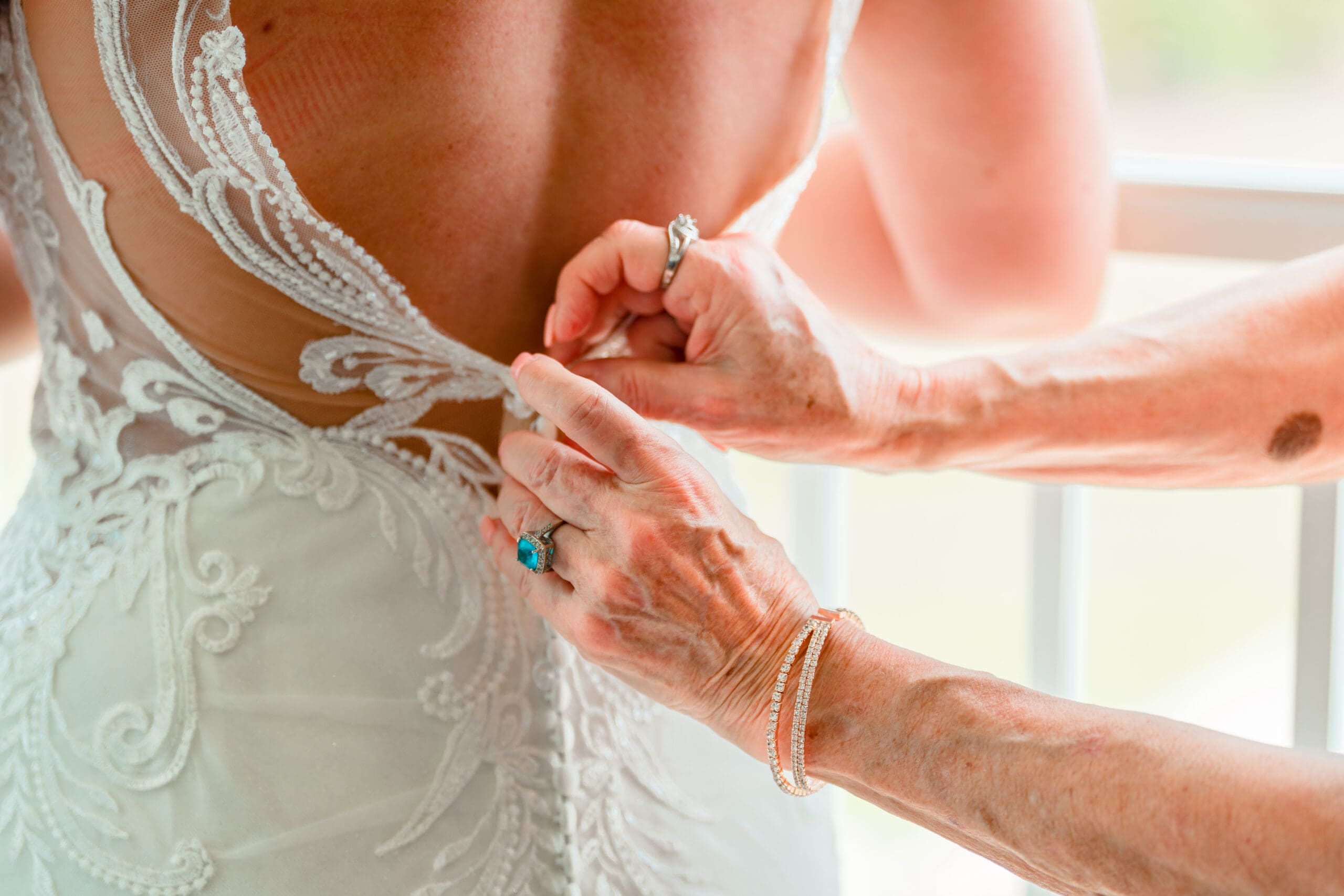 Close-Up of Mother's Hands Zipping Up Kristen's Wedding Dress