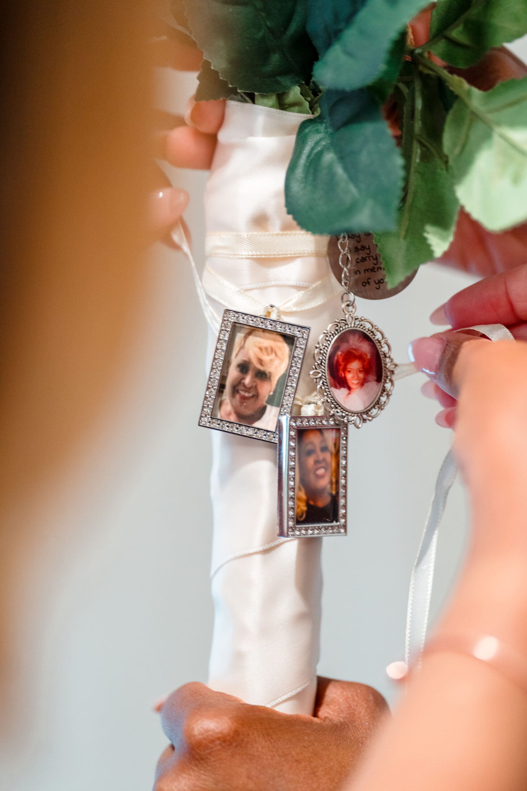 Charms with photos of loved ones attached to the base of Lateisha's bouquet.