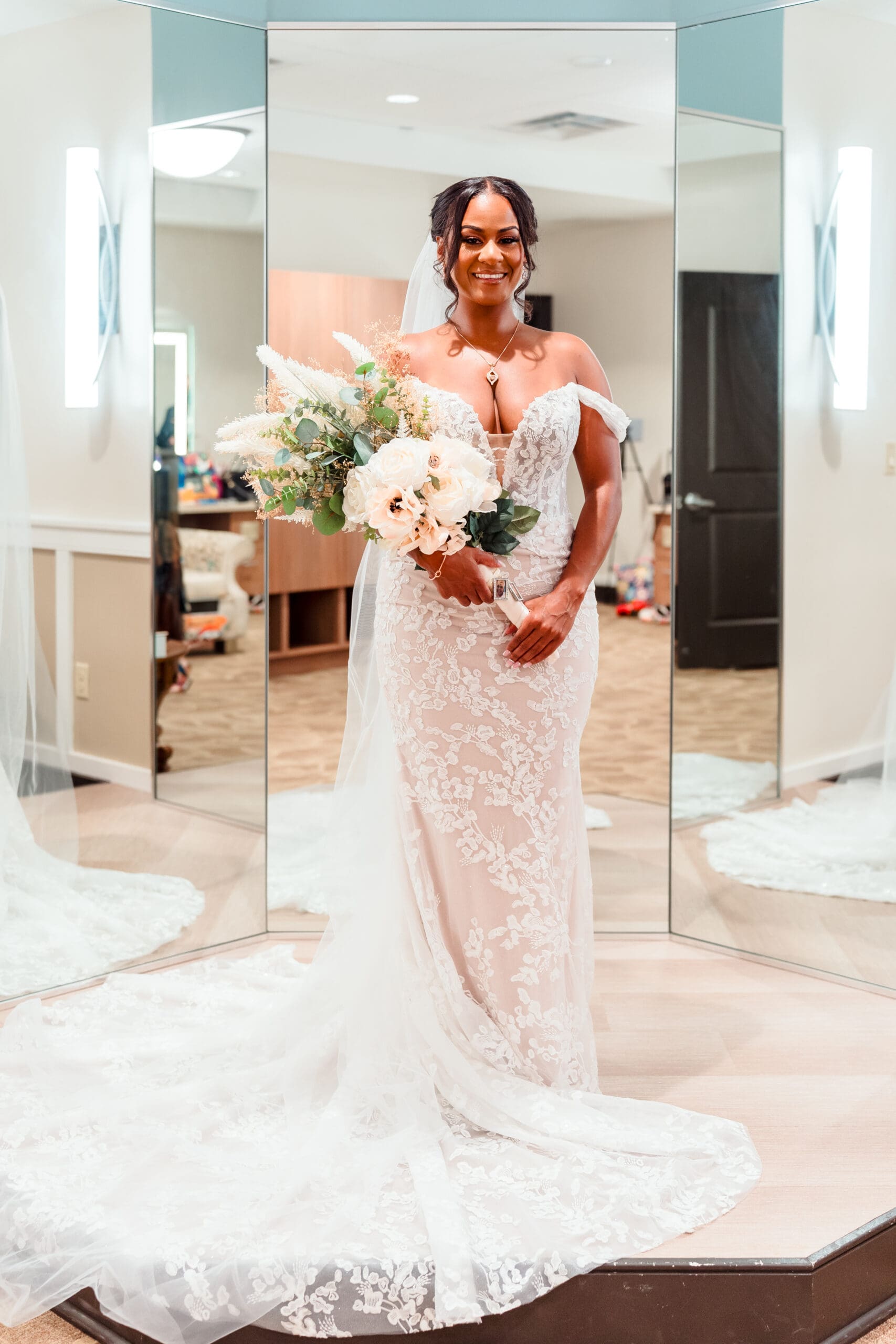 Lateisha in her wedding dress, holding her bouquet of flowers, showcasing her finished bridal look after hair and makeup.