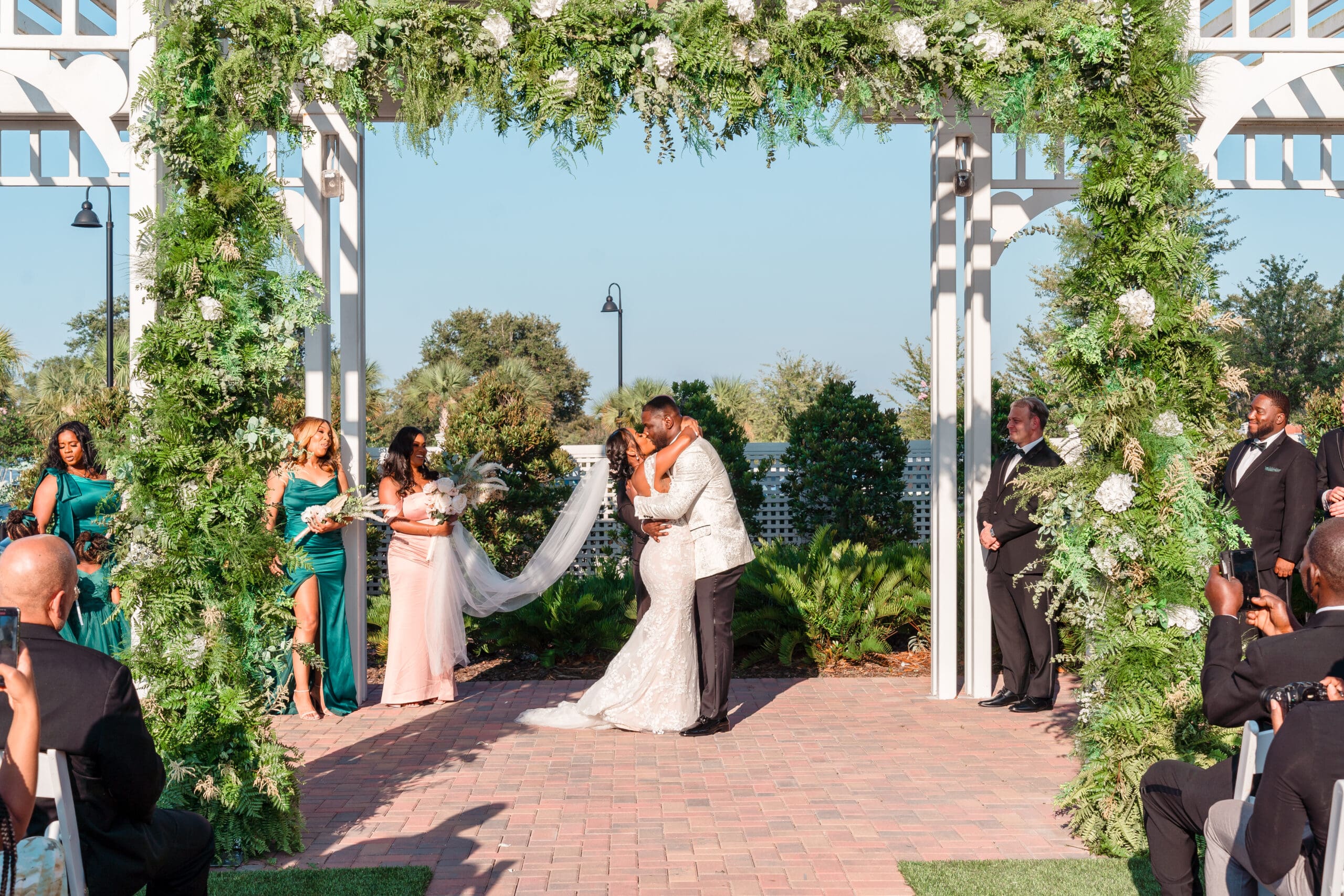 The newlyweds sharing their first kiss as husband and wife at the outdoor altar of Ocoee Lakeshore Center.