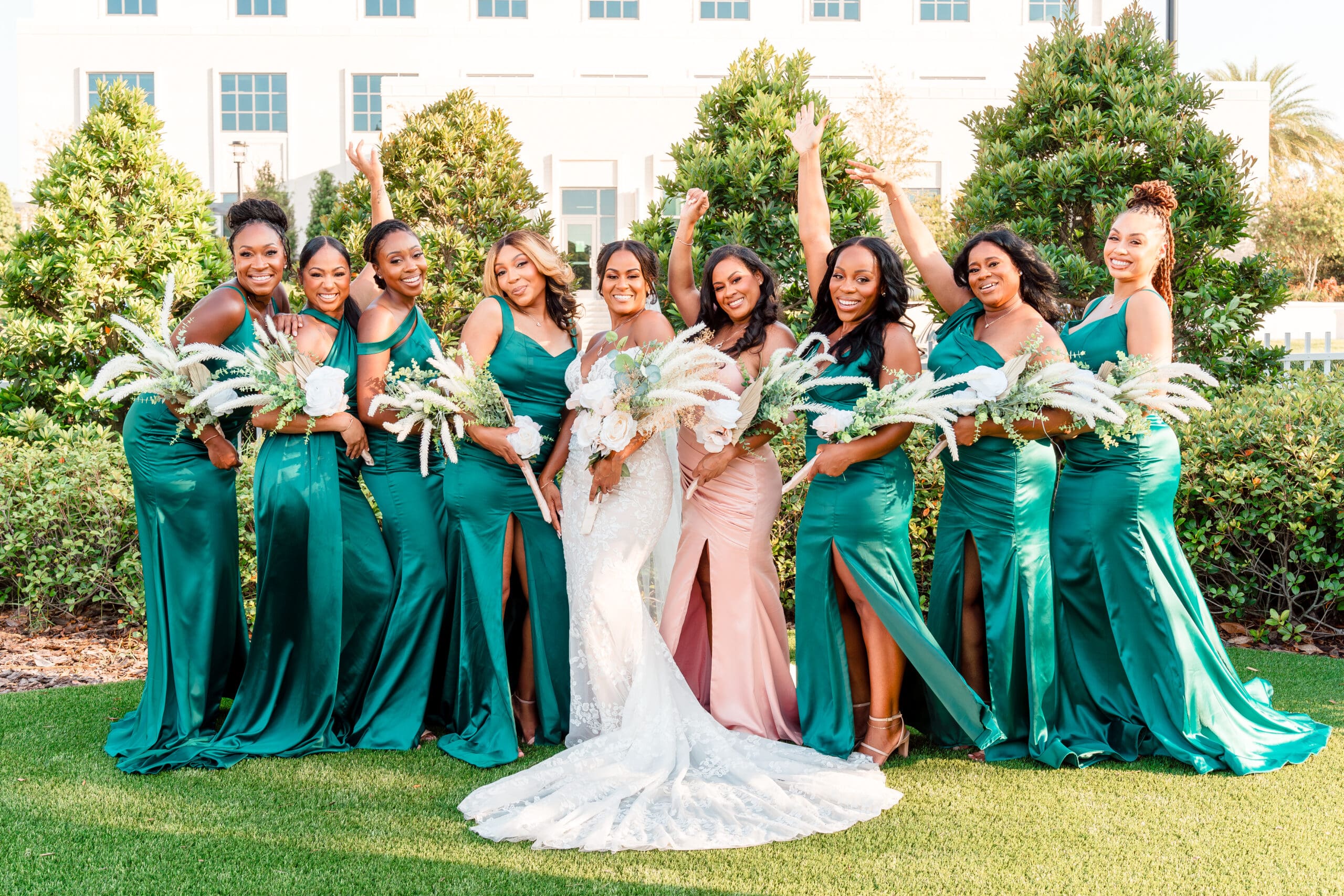 Lateisha and her bridesmaids in green dresses posing together for a celebratory photo