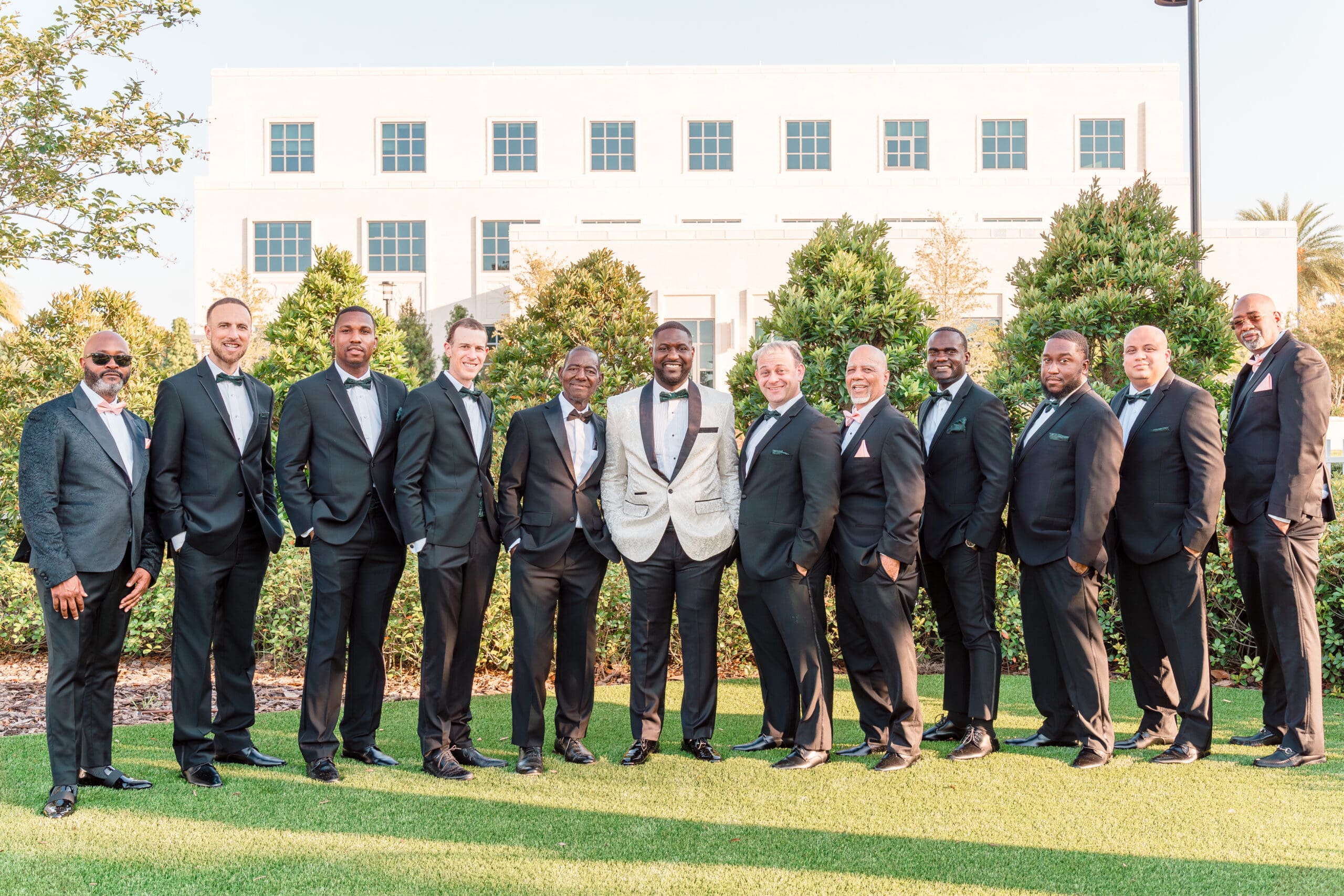 Glen posing with his 11 groomsmen in front of the Ocoee Lakeshore Center.