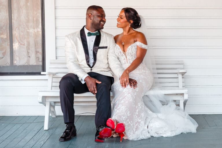 Glen and Lateisha sitting on a bench, embracing each other and gazing into each other's eyes.