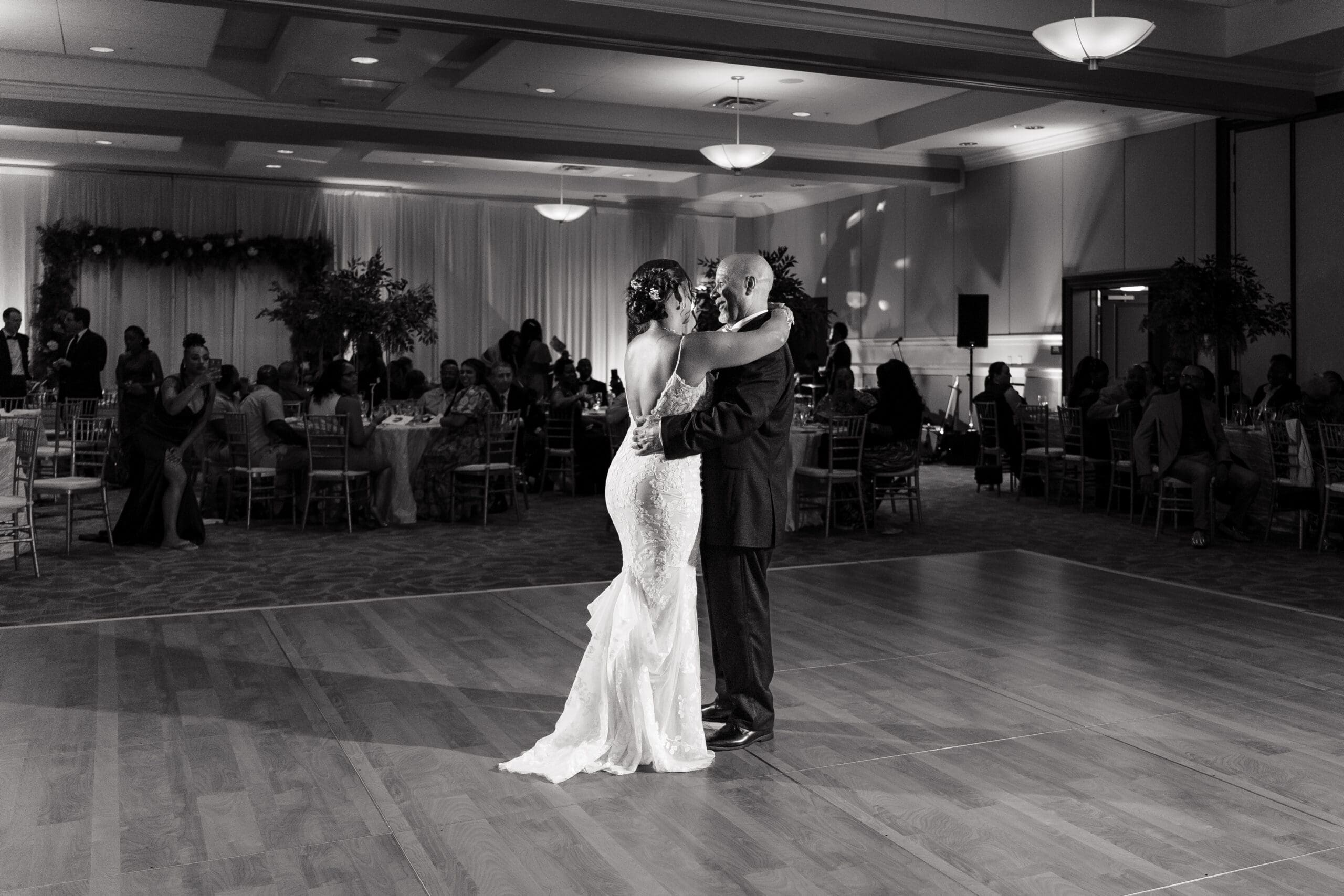 Black and white shot of Lateisha dancing with her father at Ocoee Lakeshore Reception Center.