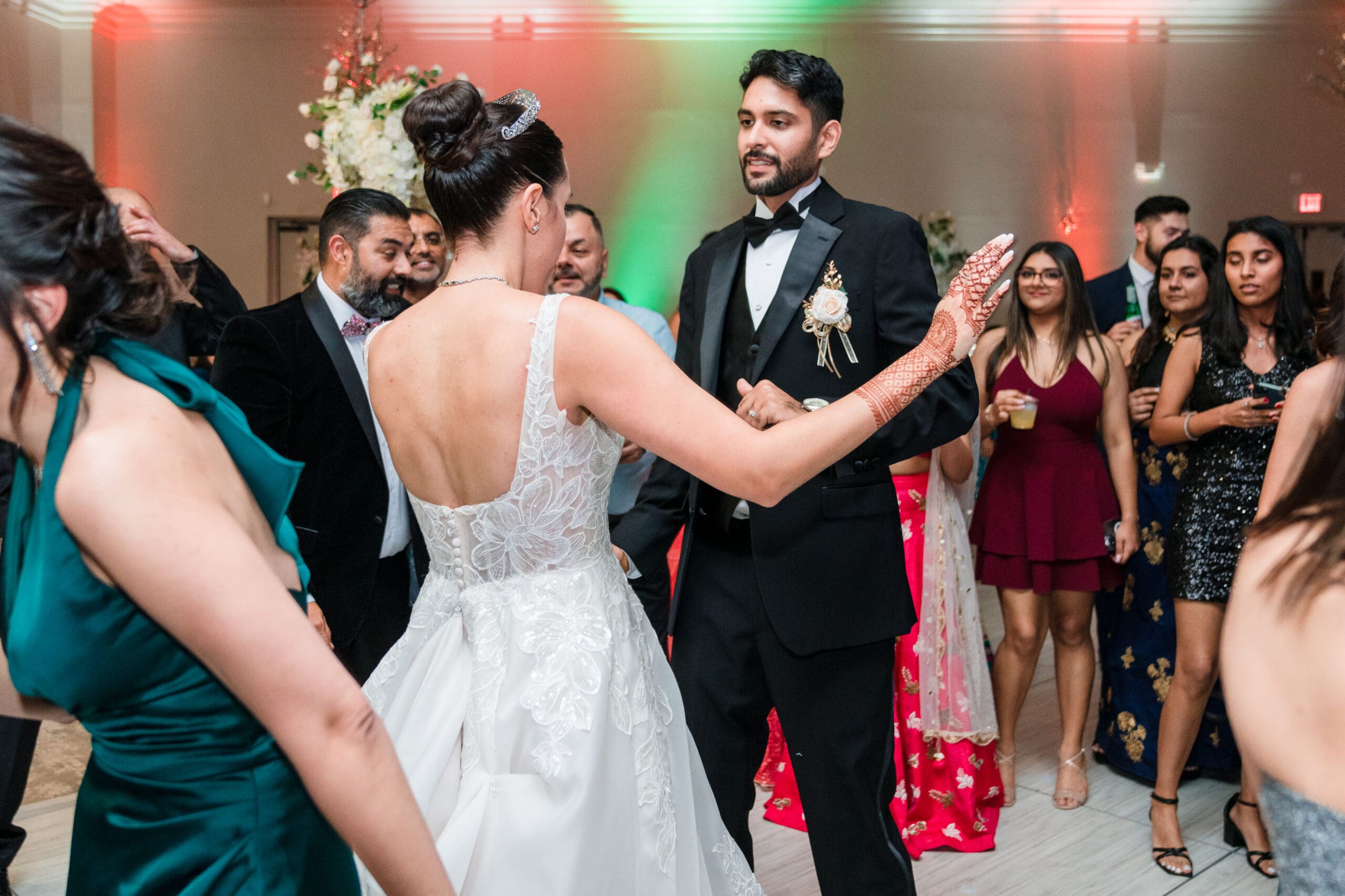 Newlyweds dancing on the dance floor surrounded by guests at Holy Trinity Reception Center