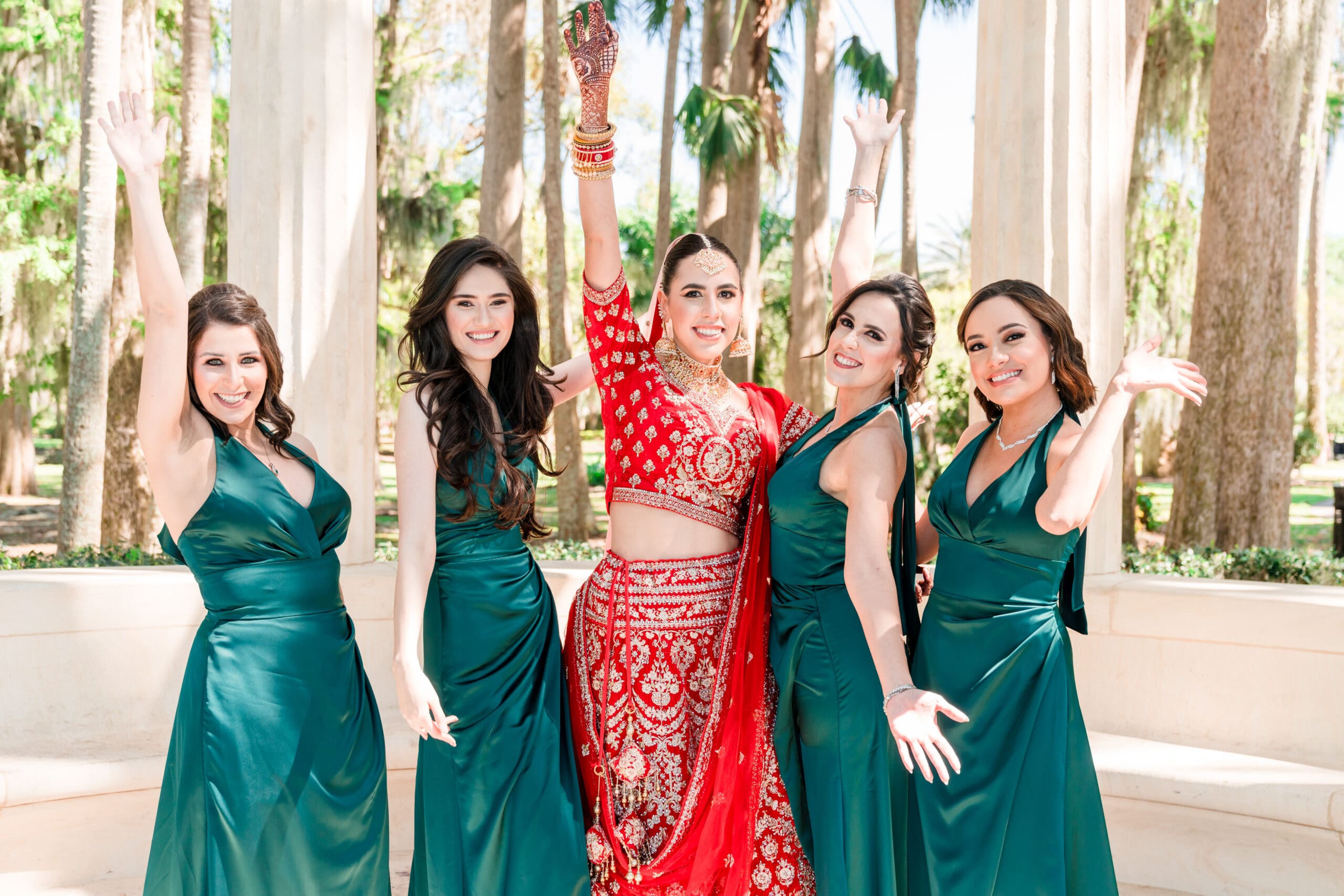 Radiant bride sharing a heartwarming moment filled with laughter and smiles alongside her beautiful bridesmaids, creating unforgettable memories at All Inclusive Weddings Orlando