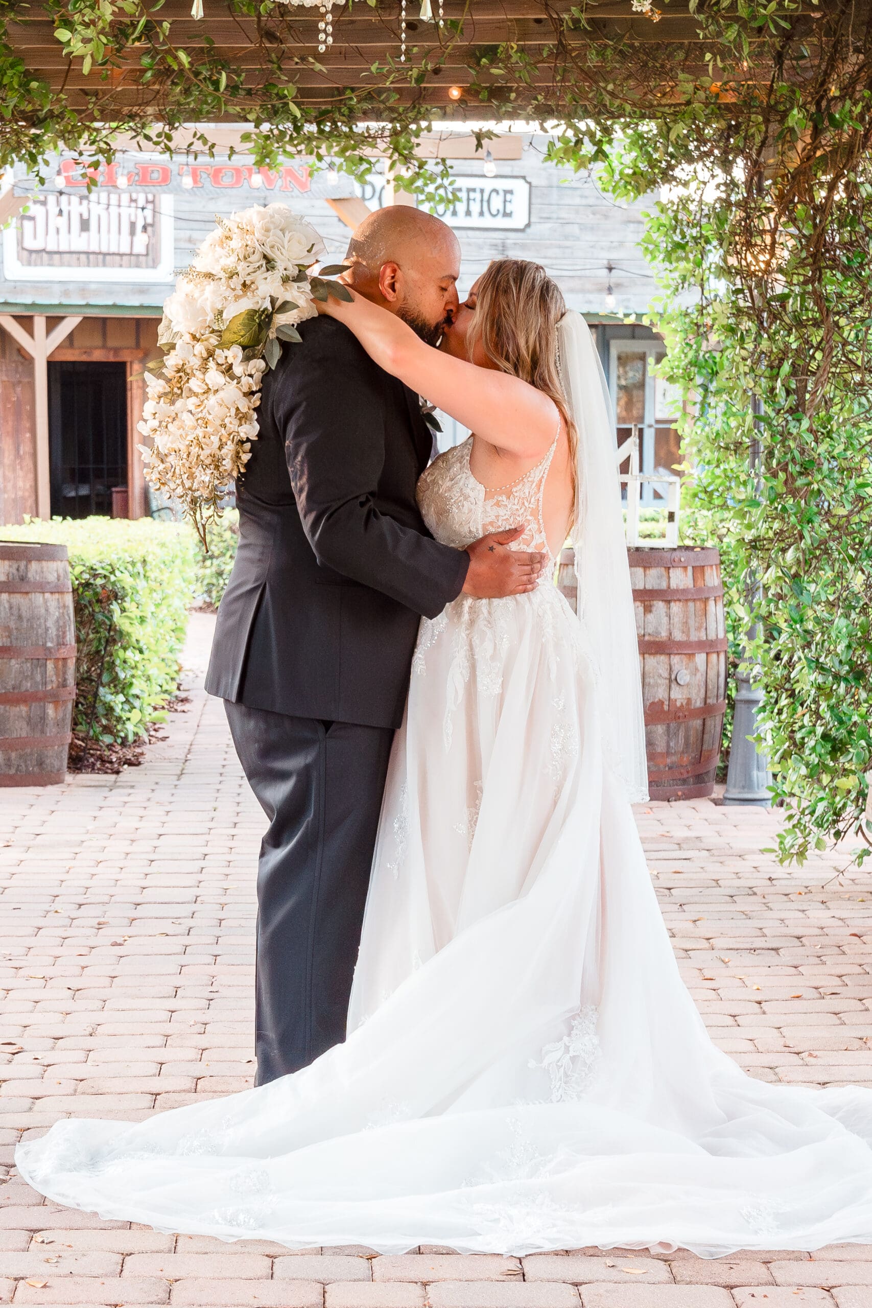 Jerzy Nieves Photography - Romantic moment captured as the bride and groom share a tender kiss, expressing their love and happiness at All Inclusive Weddings Orlando