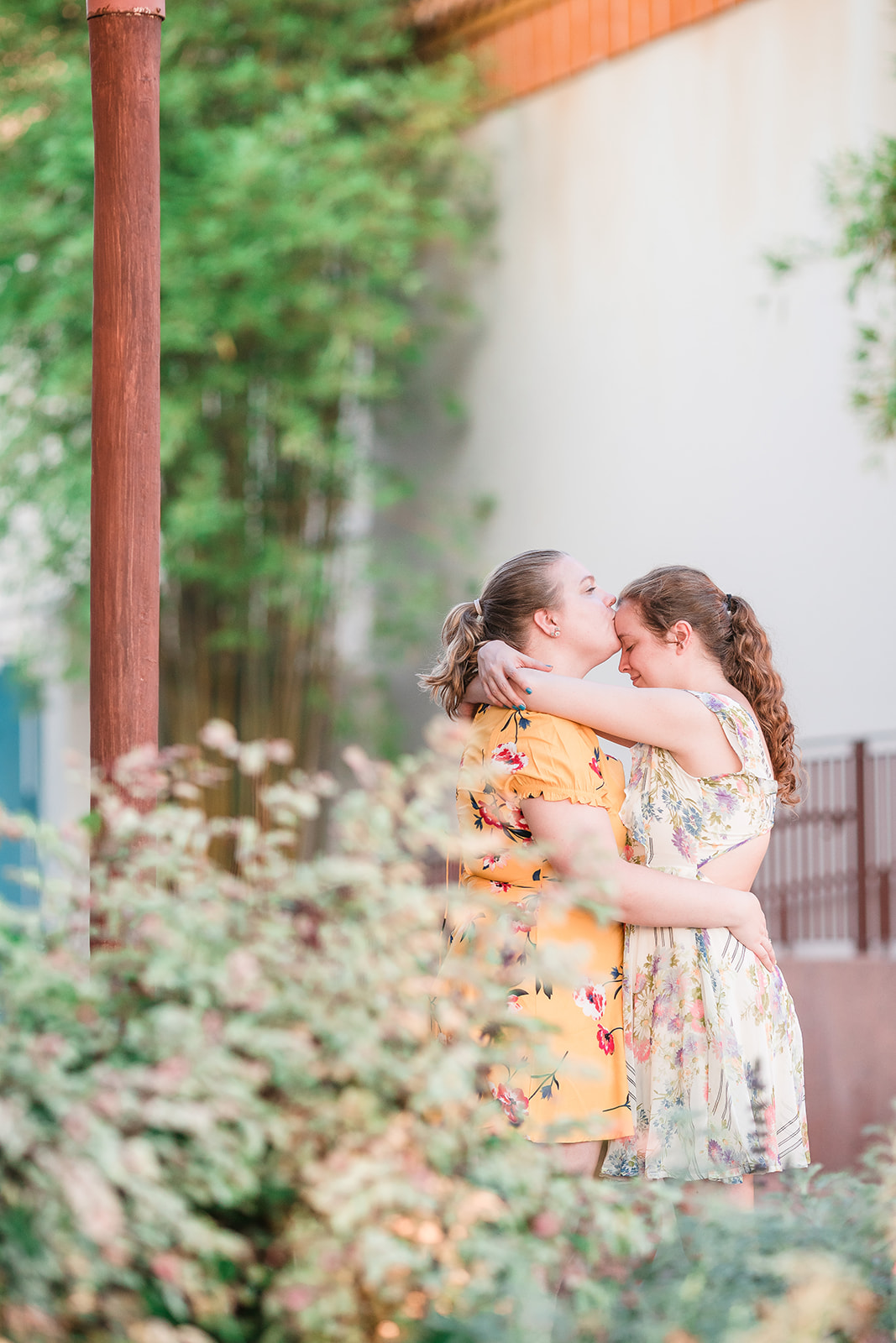 Two brides embrace in a serene and tranquil setting, surrounded by peace and love.
