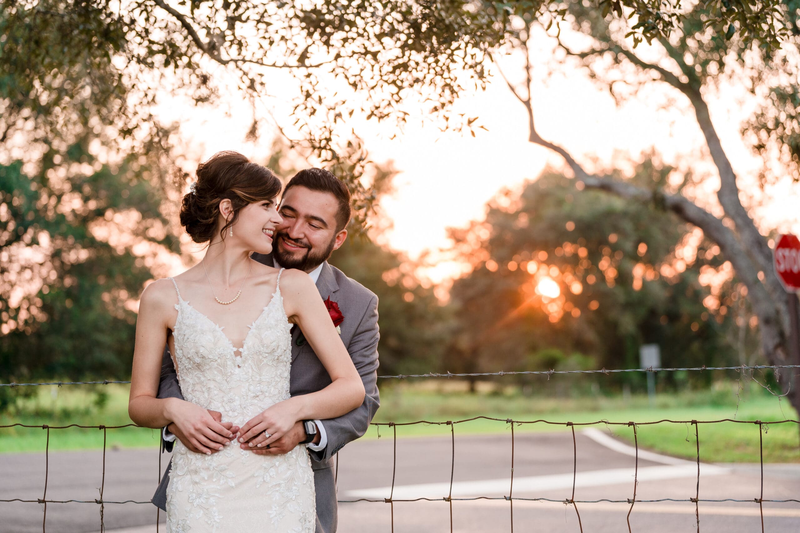 Bethany and Jonah embracing as newlyweds in the garden at Sterling Event Venue, with the sunset in the background.