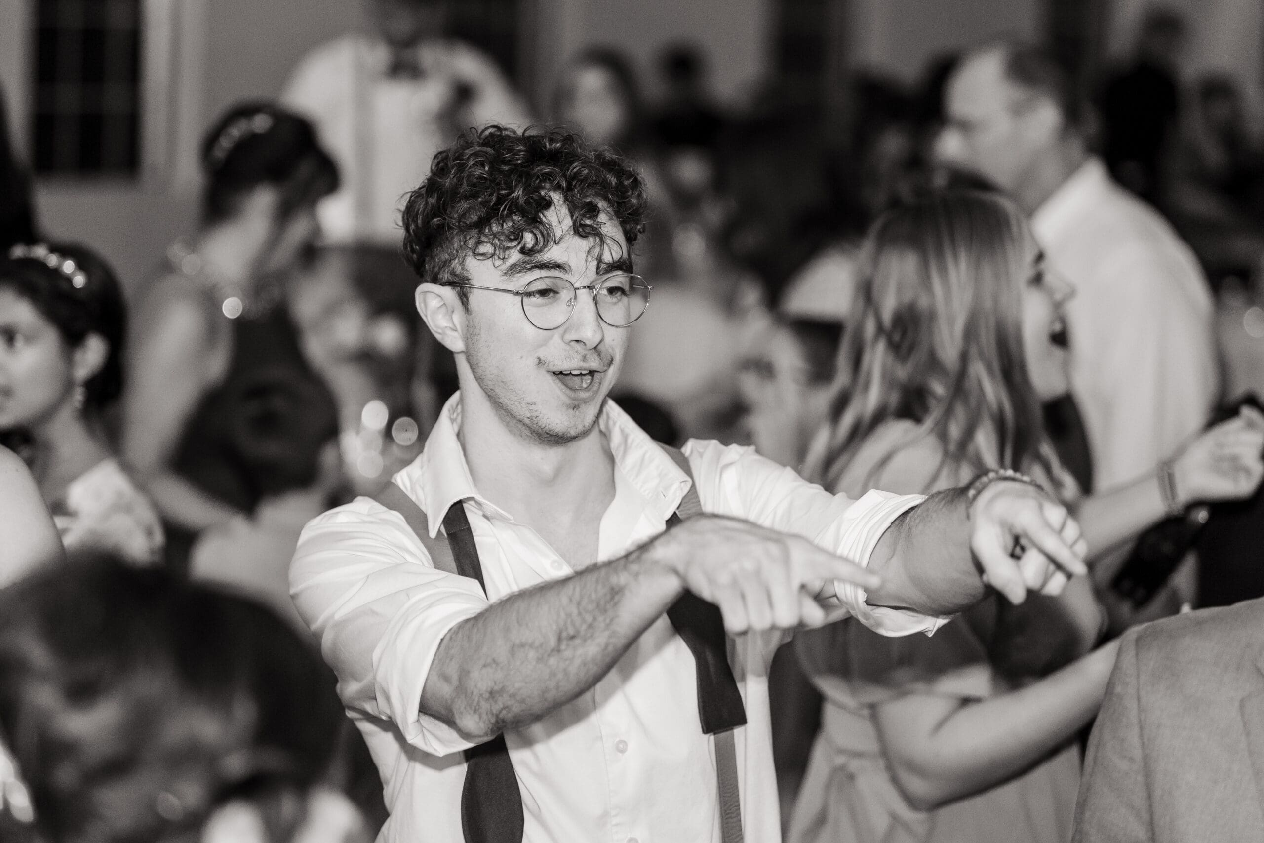 Guests enjoying themselves on the dance floor at the Sterling Event Venue Reception Center in black and white.