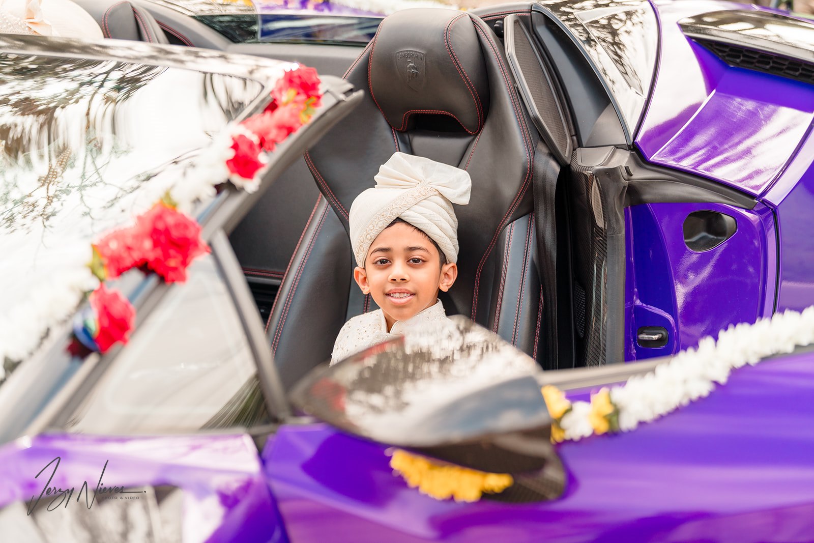 Close-up of Javin's son riding shotgun in the parade in purple Lamborghini Huracan