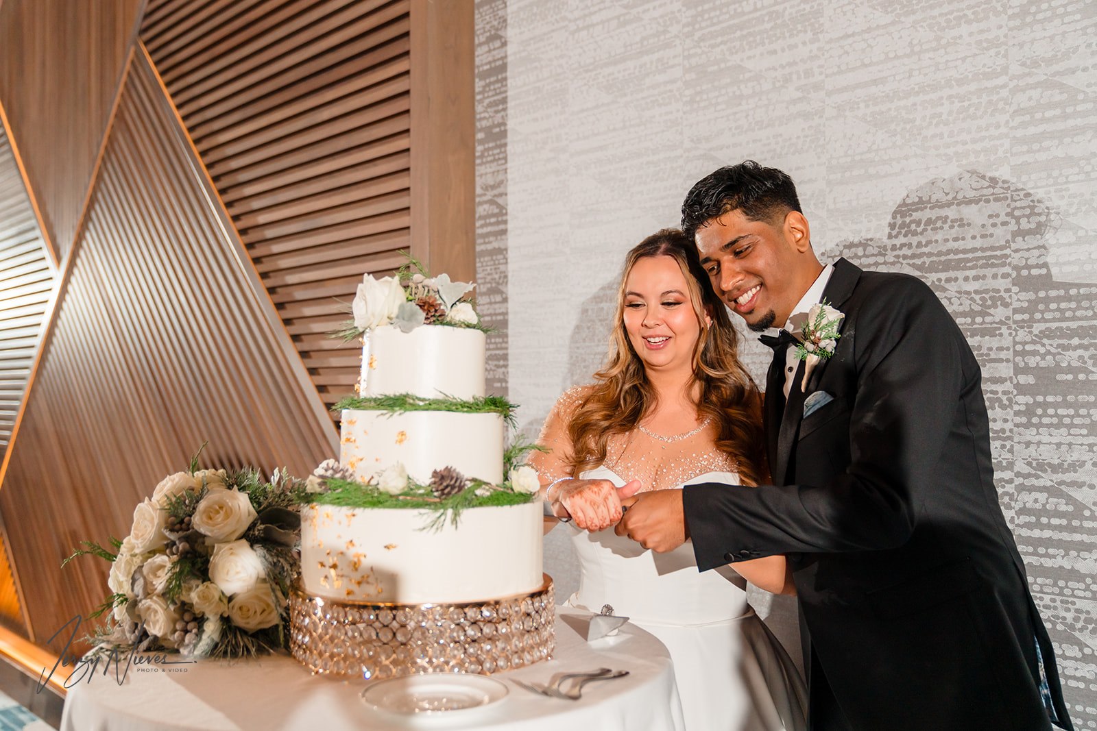 Ravin and Nicole cutting the cake at Disney Swan Reception Hall.