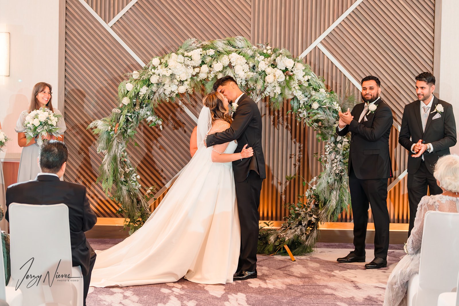 Kiss at the end of the ceremony: Nicole and Ravin embrace passionately at the altar of Disney Swan Reserve.