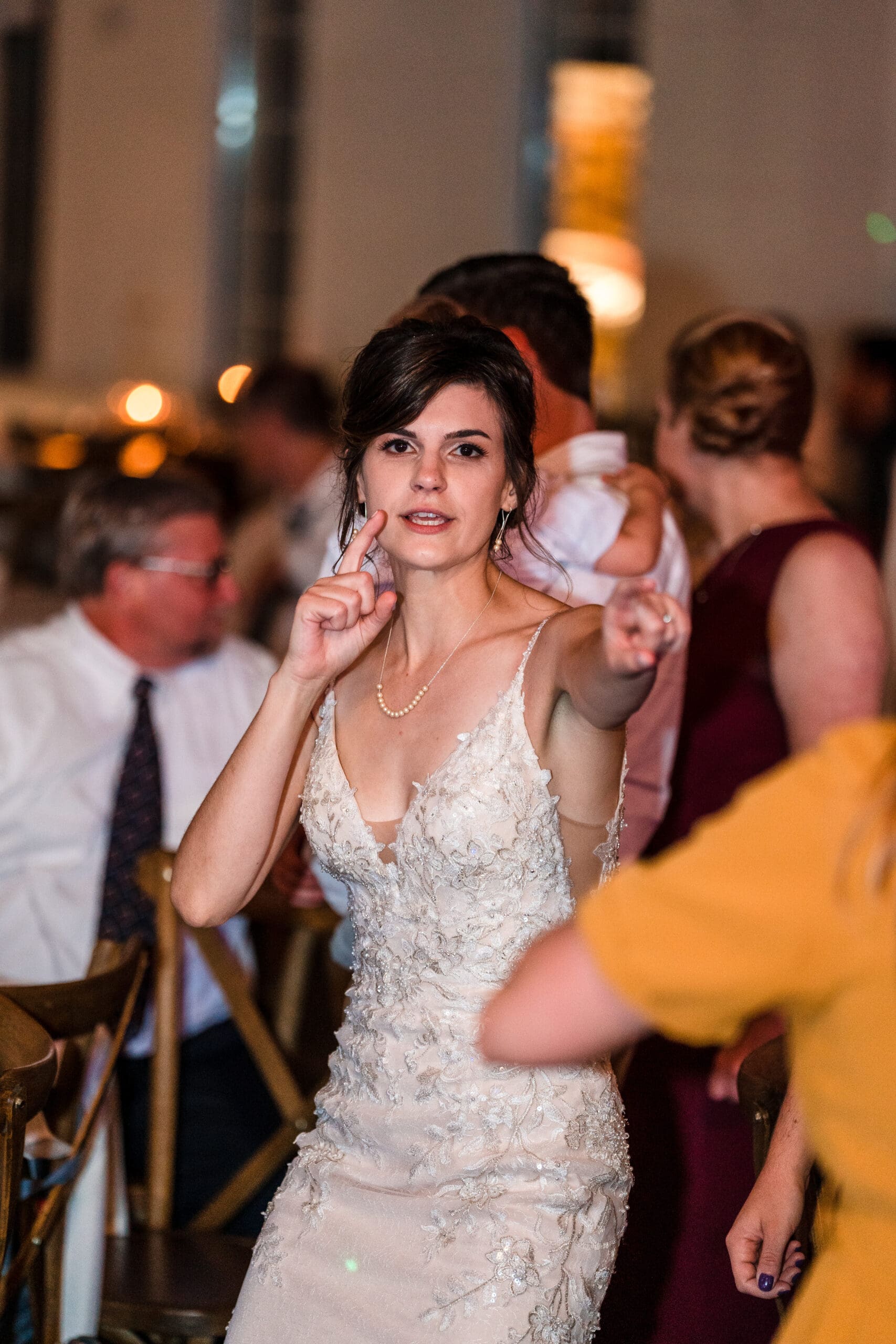 Bethany pointing at the camera during a dance move at the Sterling Event Venue Reception Center.