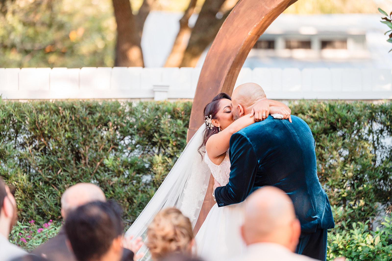 Close-up of the kiss between the bride and groom at Venue 1902's garden altar.