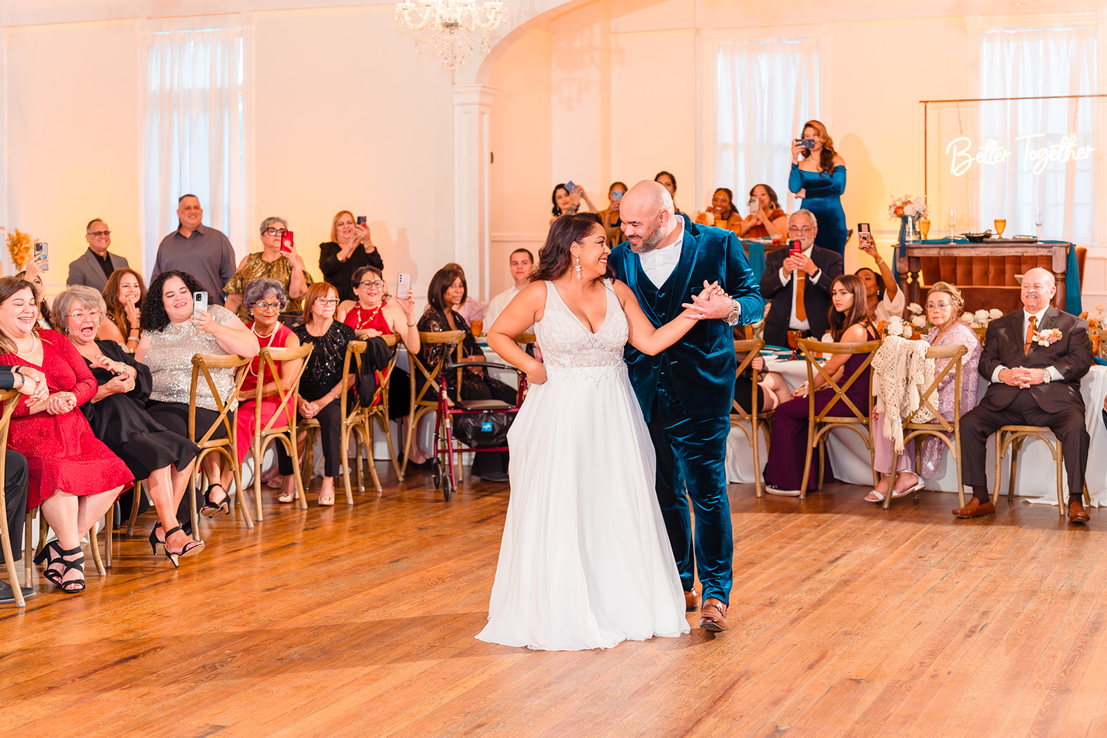 Close-up of the newlyweds' first dance at Venue 1902's reception hall, surrounded by smiling guests.