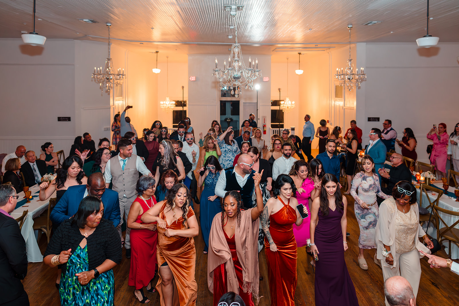 Overhead shot of Margaux and Alberto, surrounded by guests, dancing together on the dance floor at Venue 1902.
