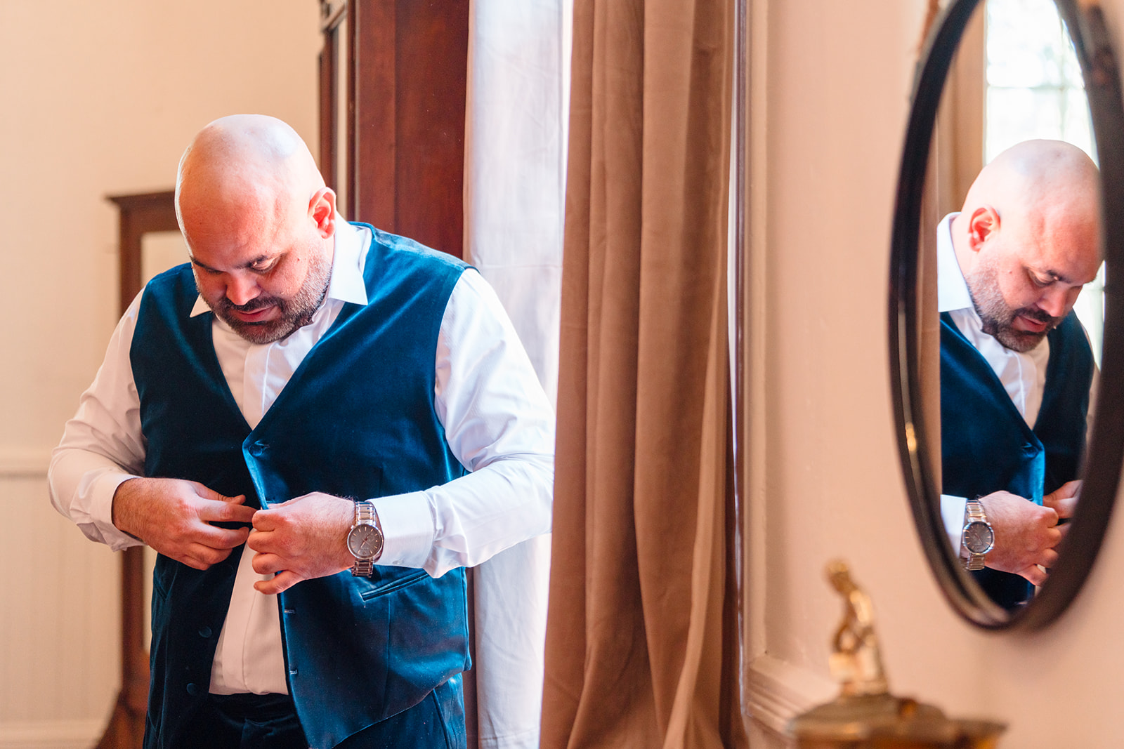 Pre-wedding moment: Alberto buttoning his vest in preparation for his big day at Venue 1902
