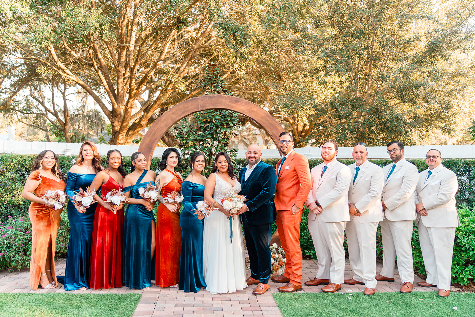 Margaux and Alberto with the bridal party posing at the outdoor altar of Venue 1902 for a classic wedding pose, captured by Jerzy Nieves Photography.