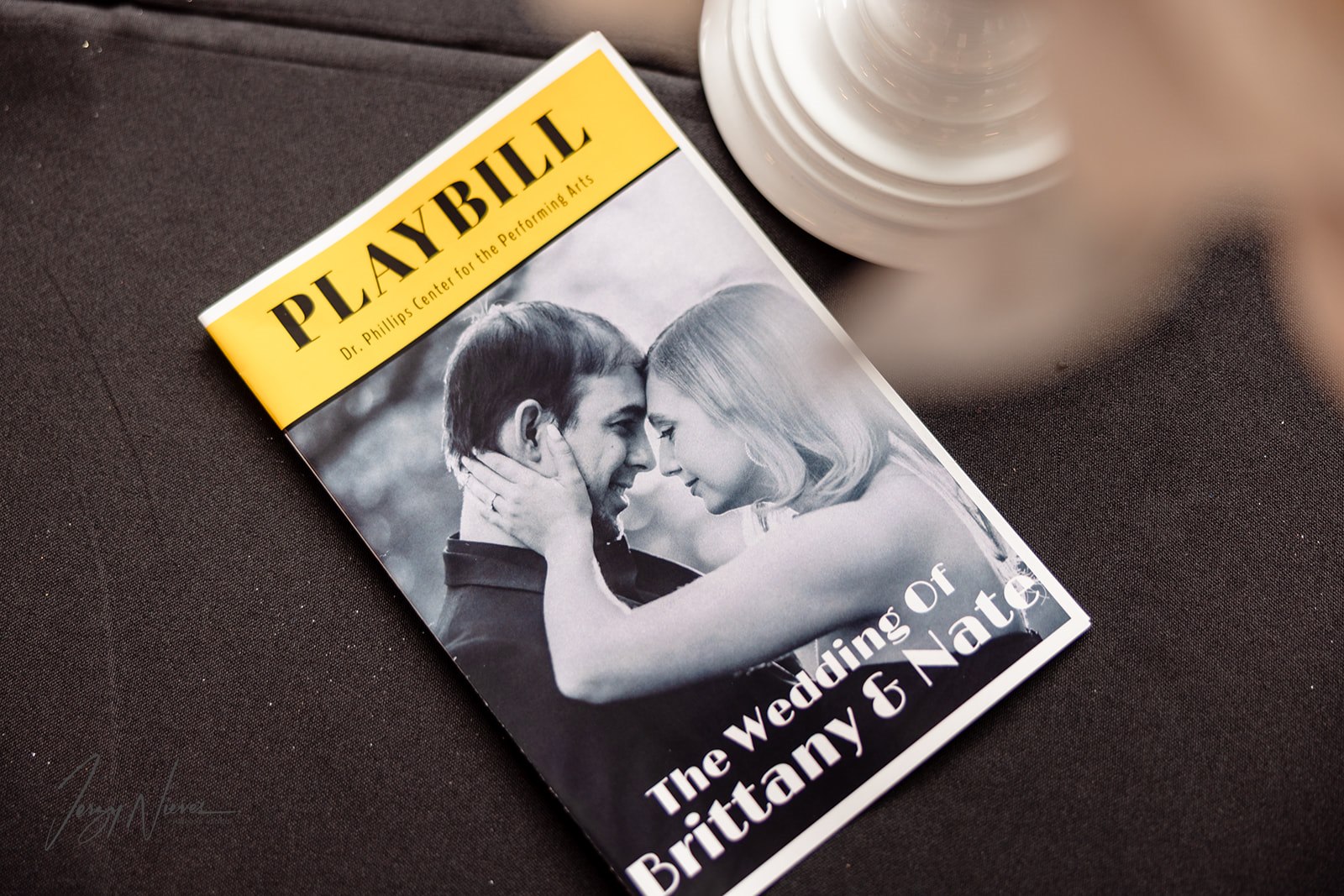 Special wedding playbill featuring the couple embracing on the cover, with the Dr. Phillips Center for the Performing Arts in the background.