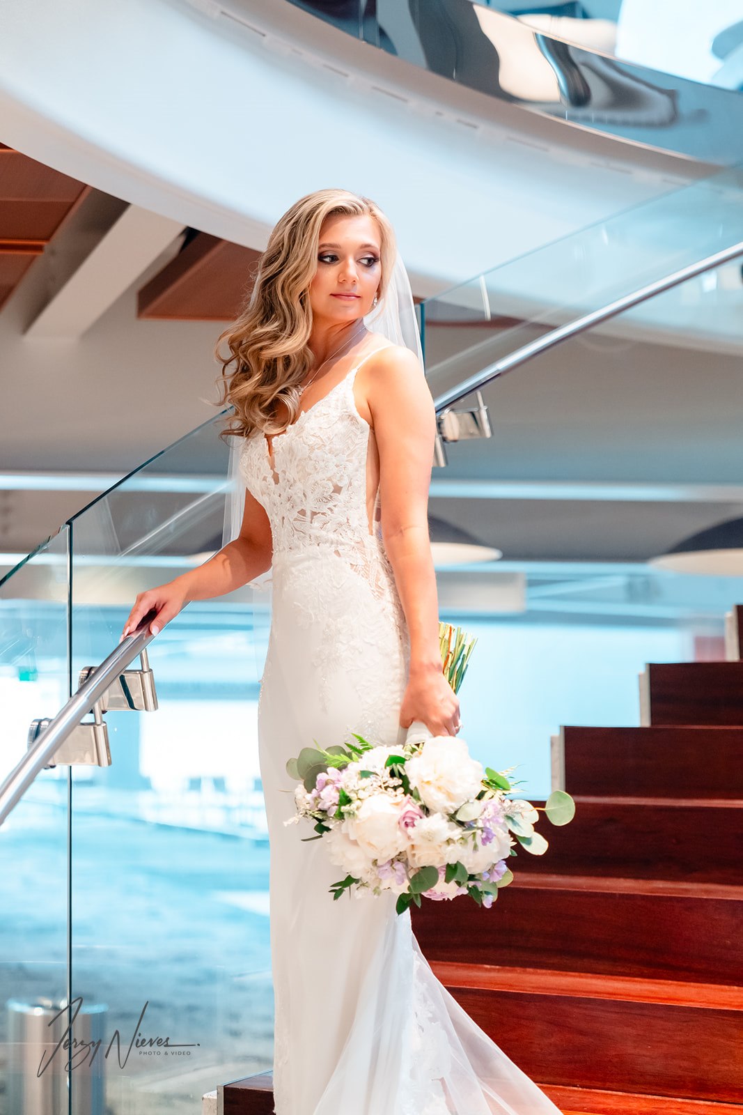 Bride standing on the stairs of the Dr. Phillips Center in her wedding dress, radiating elegance and anticipation before the ceremony.