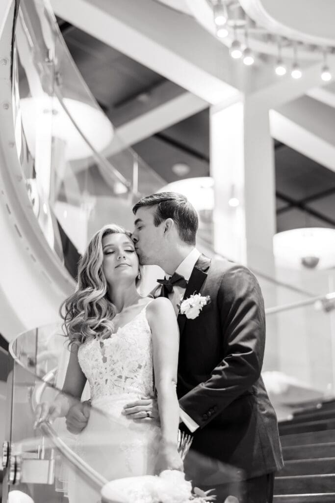 Orlando Wedding Photography - Groom Holding Bride In Black And White Photo at Dr. Phillips Center for the Art Weddings