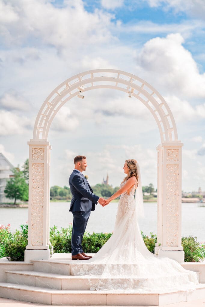 Disney wedding couple holding hands during sunset in Magic Kingdom