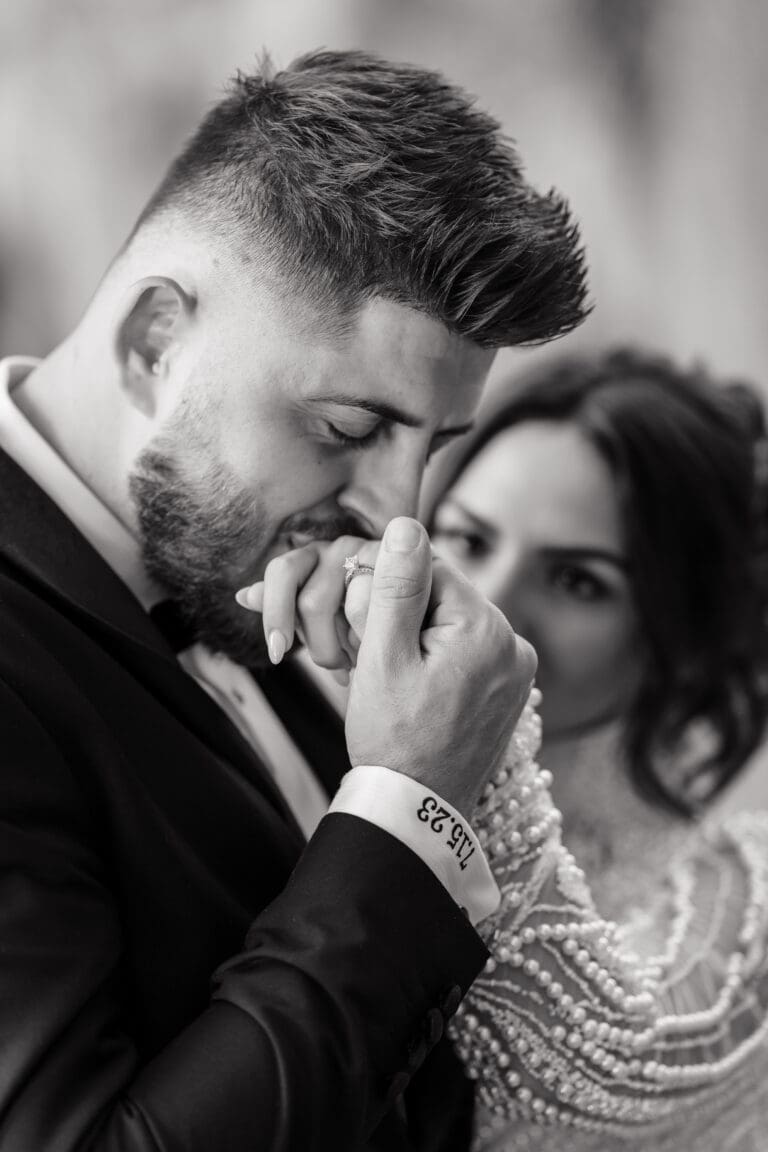 Elegant bride and groom pose in front of a historic church, celebrating their luxury wedding with timeless style. The bride’s flowing gown and the groom’s sharp tuxedo complement the church’s intricate architecture, creating a picture-perfect moment in Orlando, Florida.