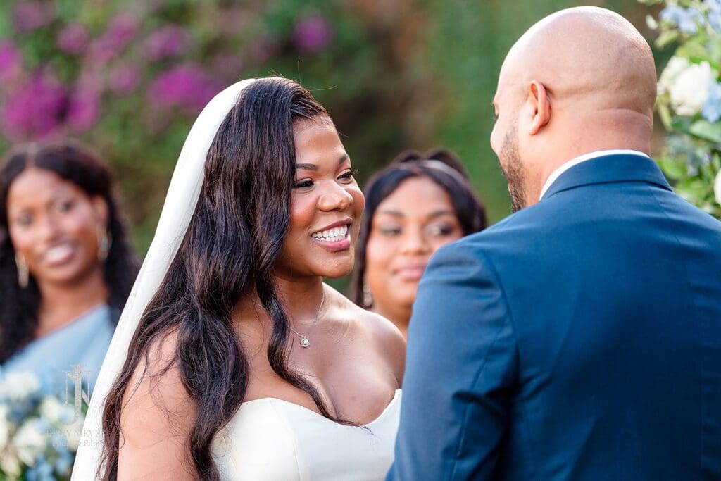 bride smiling at groom at wedding ceremony