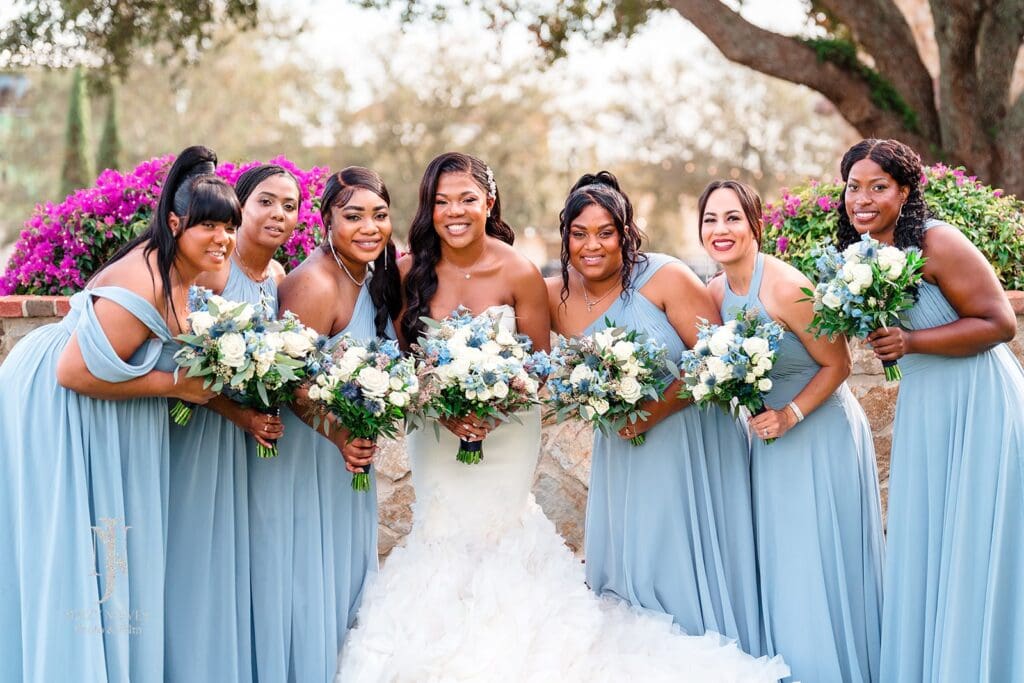 bridesmaids wearing light blue with bride wearing white