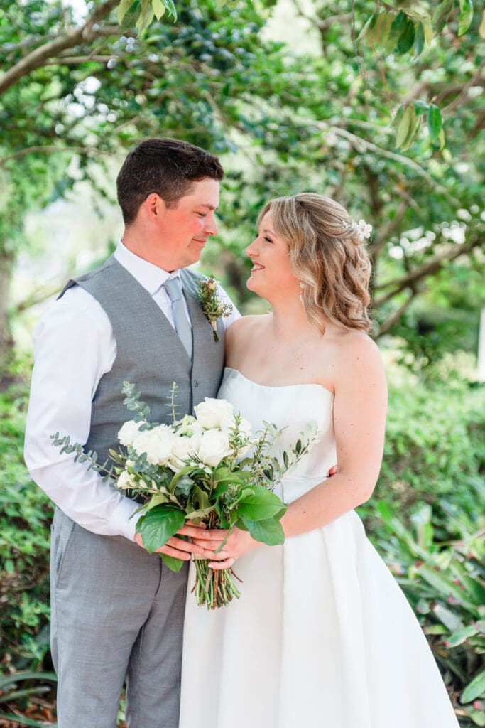 Golden hour bride and groom portrait surrounded by greenery in Orlando