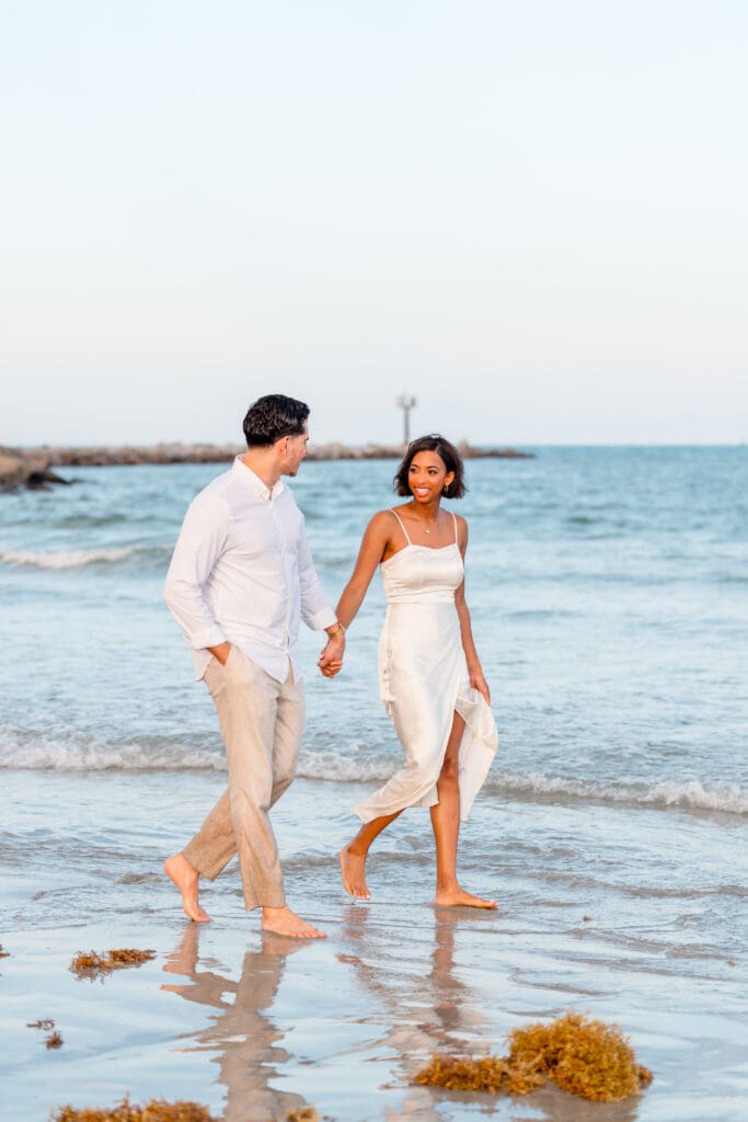 Marissa laughing during engagement photos at Jetty Park Beach in Cocoa, FL