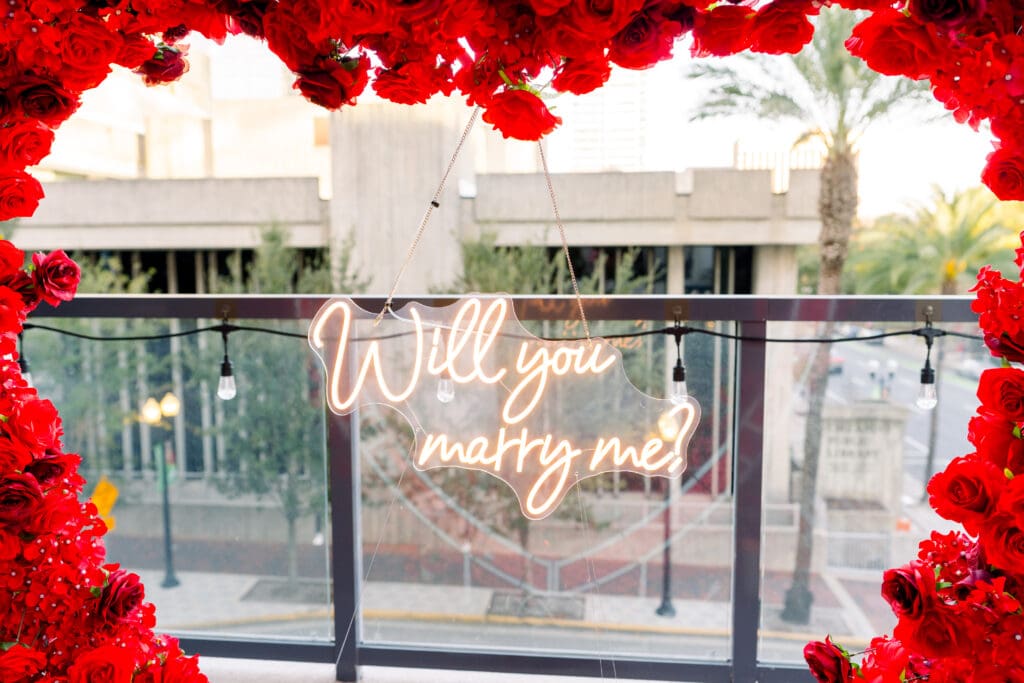 Emotional surprise proposal in Downtown Orlando at Eola View with city skyline