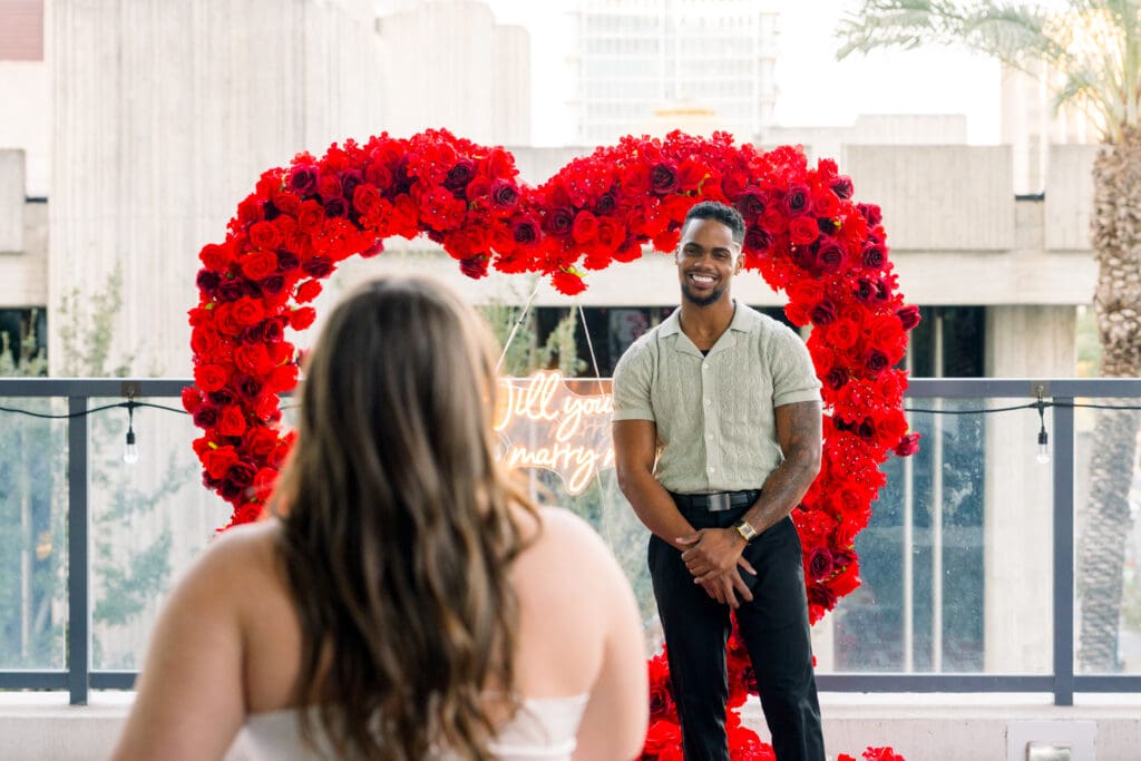 Emotional surprise proposal in Downtown Orlando at Eola View with city skyline