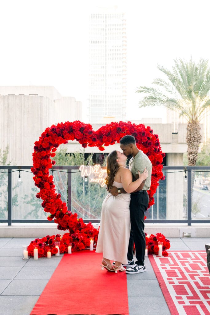 Emotional surprise proposal in Downtown Orlando at Eola View with city skyline