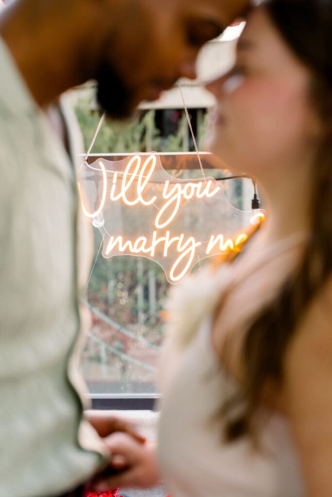 Emotional surprise proposal in Downtown Orlando at Eola View with city skyline