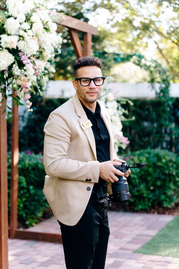A portrait of Jerzy nieves holding a camera at a orlando wedding